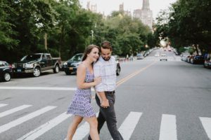 Manhattan engaged couple crossing the street