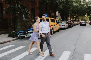 Manhattan engaged couple crossing the street