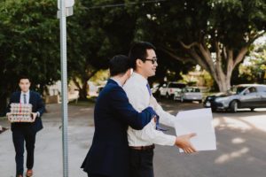 SmogShoppe LA groom hugging guest