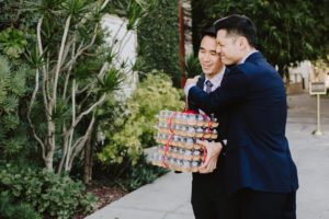 SmogShoppe LA groom hugging guest