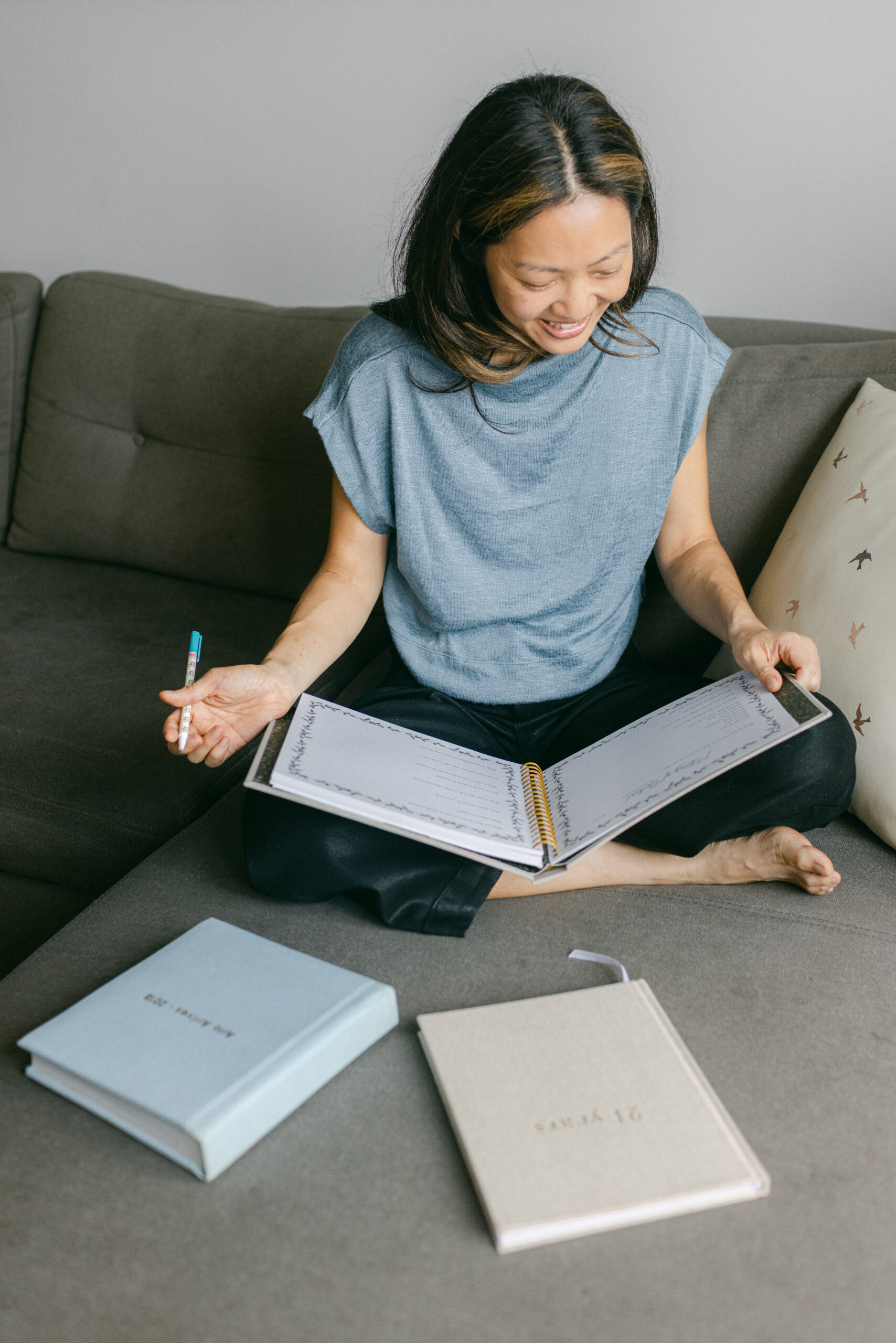 A woman with journals for her brand photos