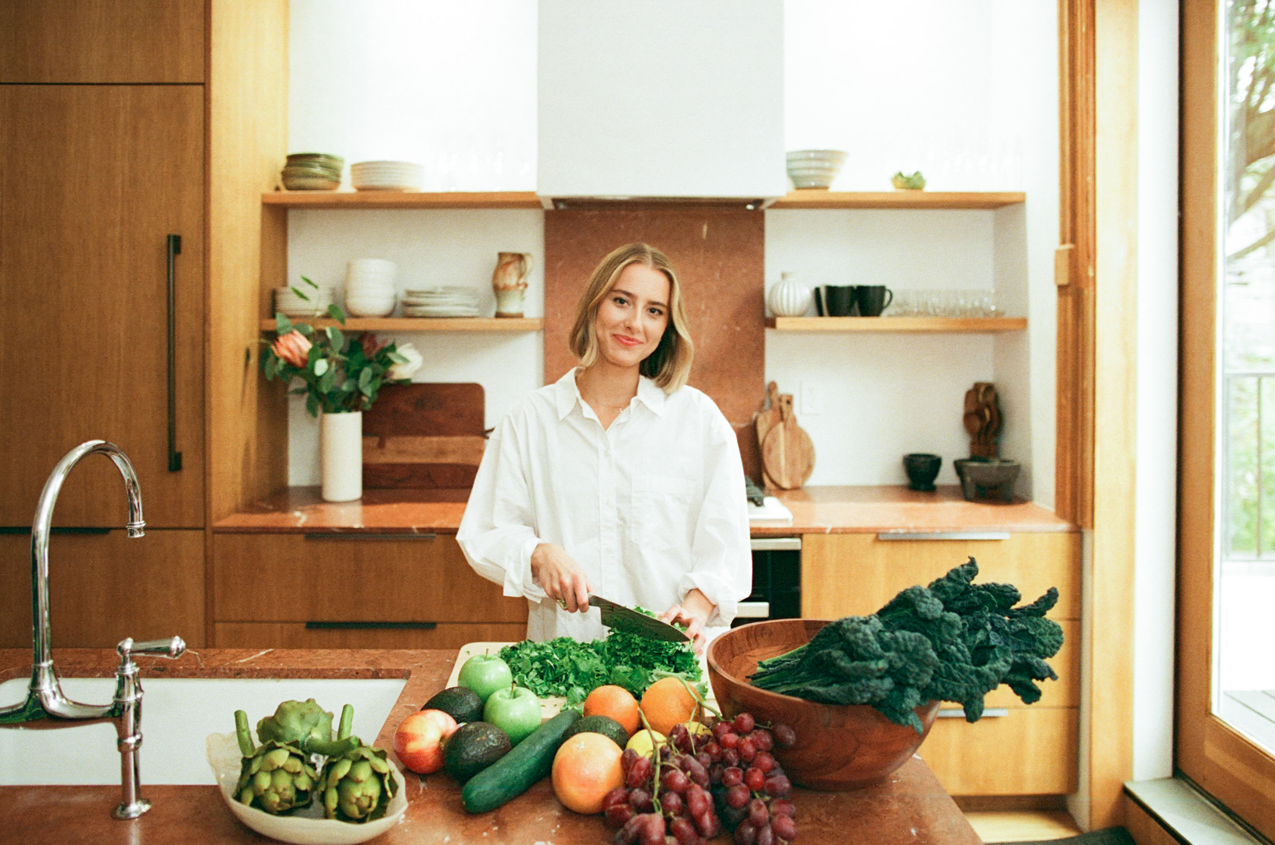 A girl chopping vegetables during her branding photoshoot in NYC
