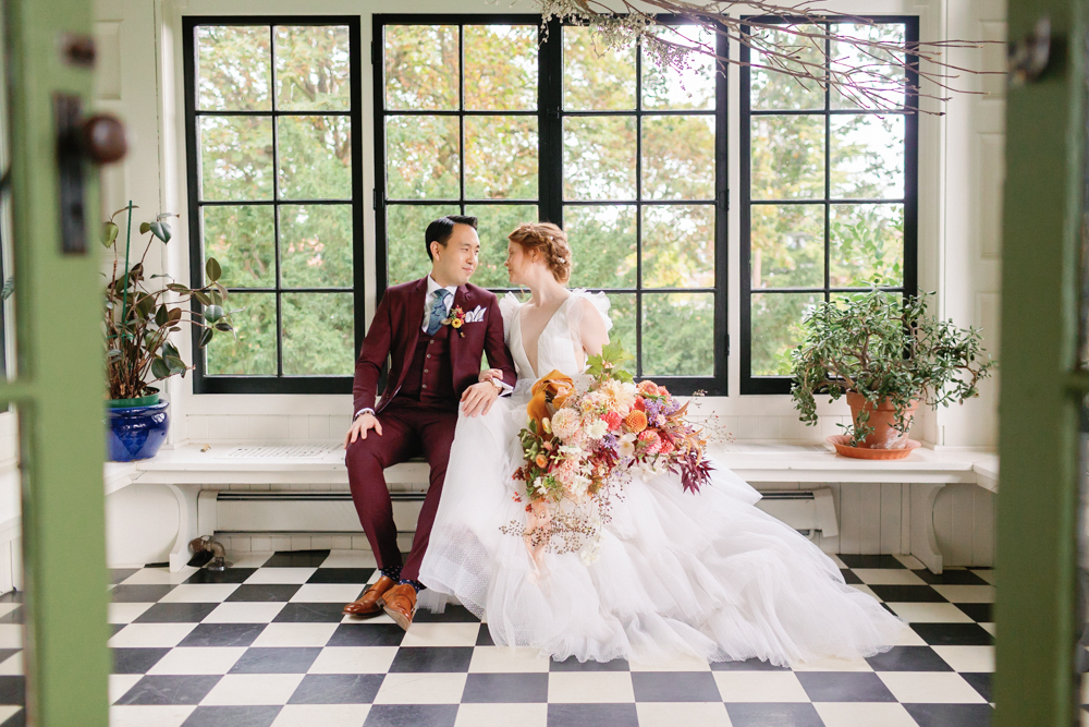 Bride and groom with lush florals for their wedding day