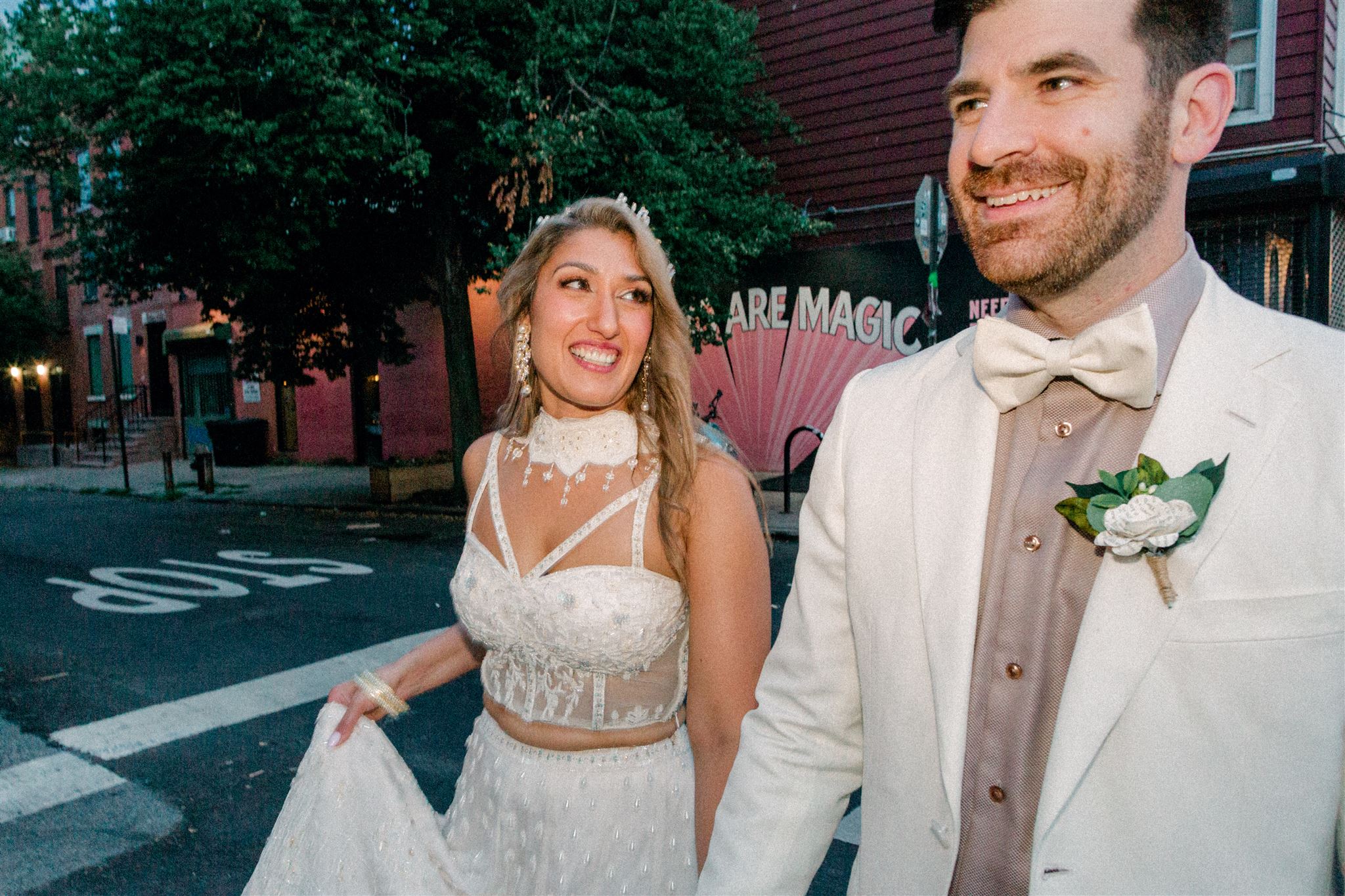 Bride and groom crossing the street smiling in New York City