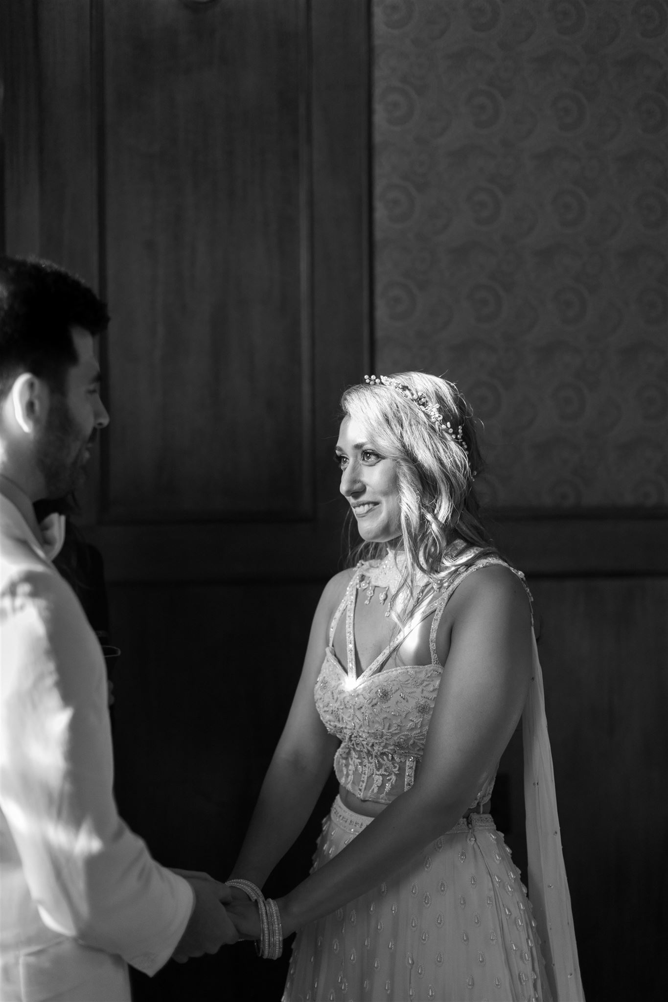 Black and white photo of a bride and groom saying their vows to one another at The Clover Club in New York City
