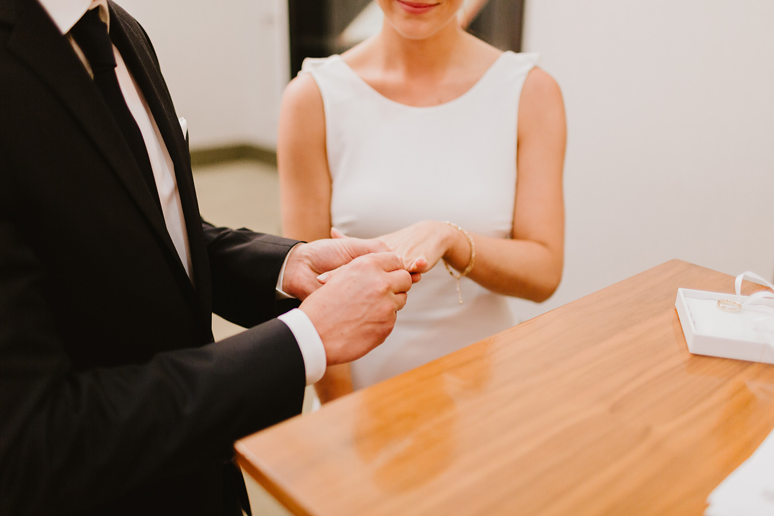 a man putting a ring on a womans finger during their elopement 