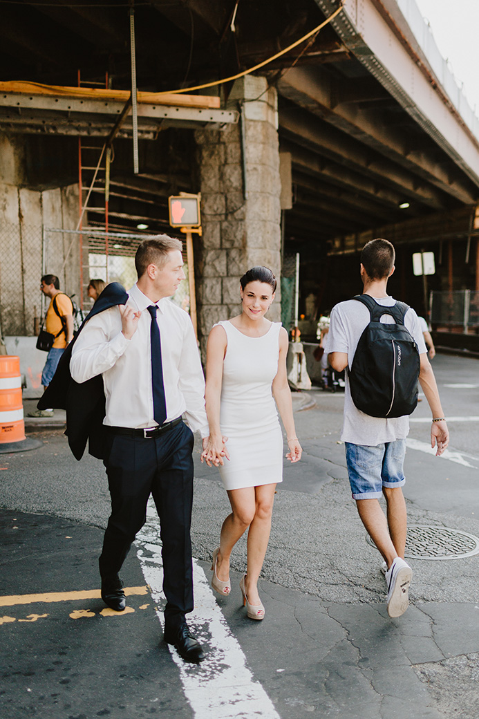 a man and a woman walking hand in hand in NYC for their NYC elopement photography