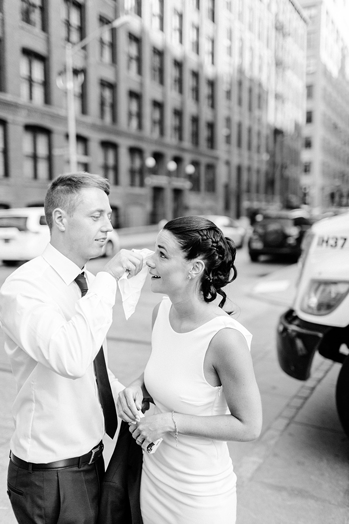 a man giving his new wife a gift after they eloped at nyc city hall