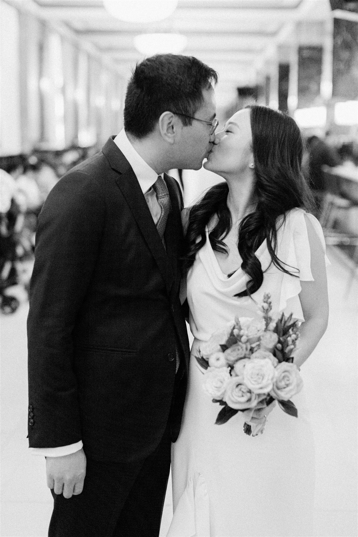 bride and groom kissing at NYC city hall 