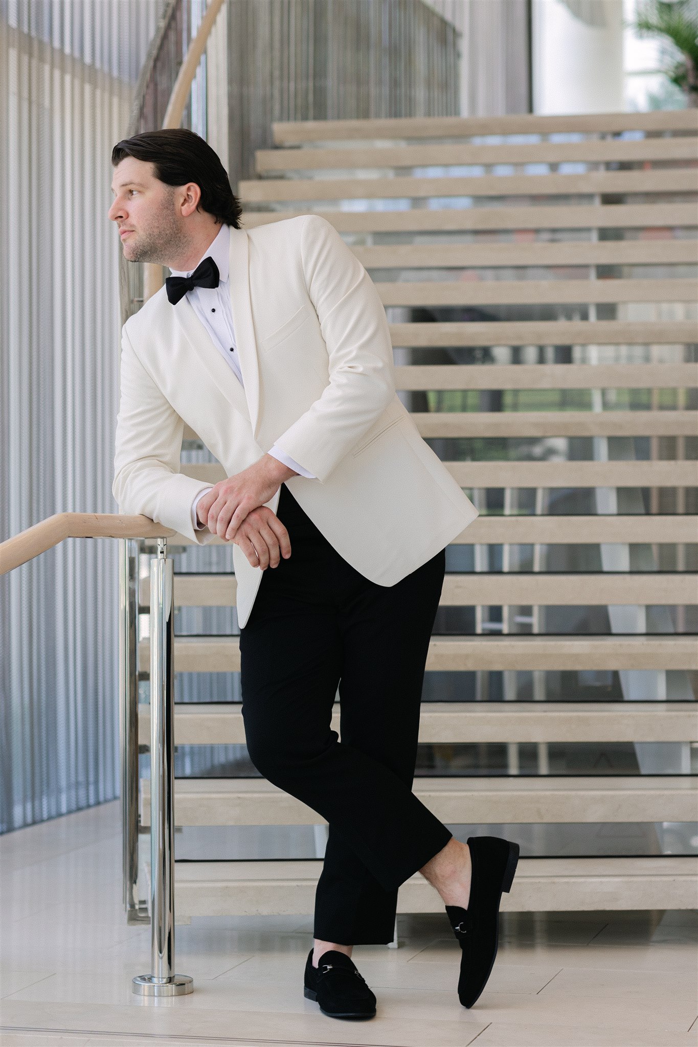 groom standing on the staircase at Hall Arts Hotel