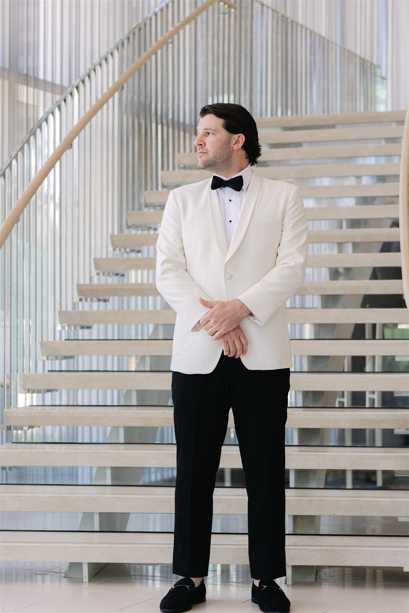 groom standing on the staircase at Hall Arts Hotel