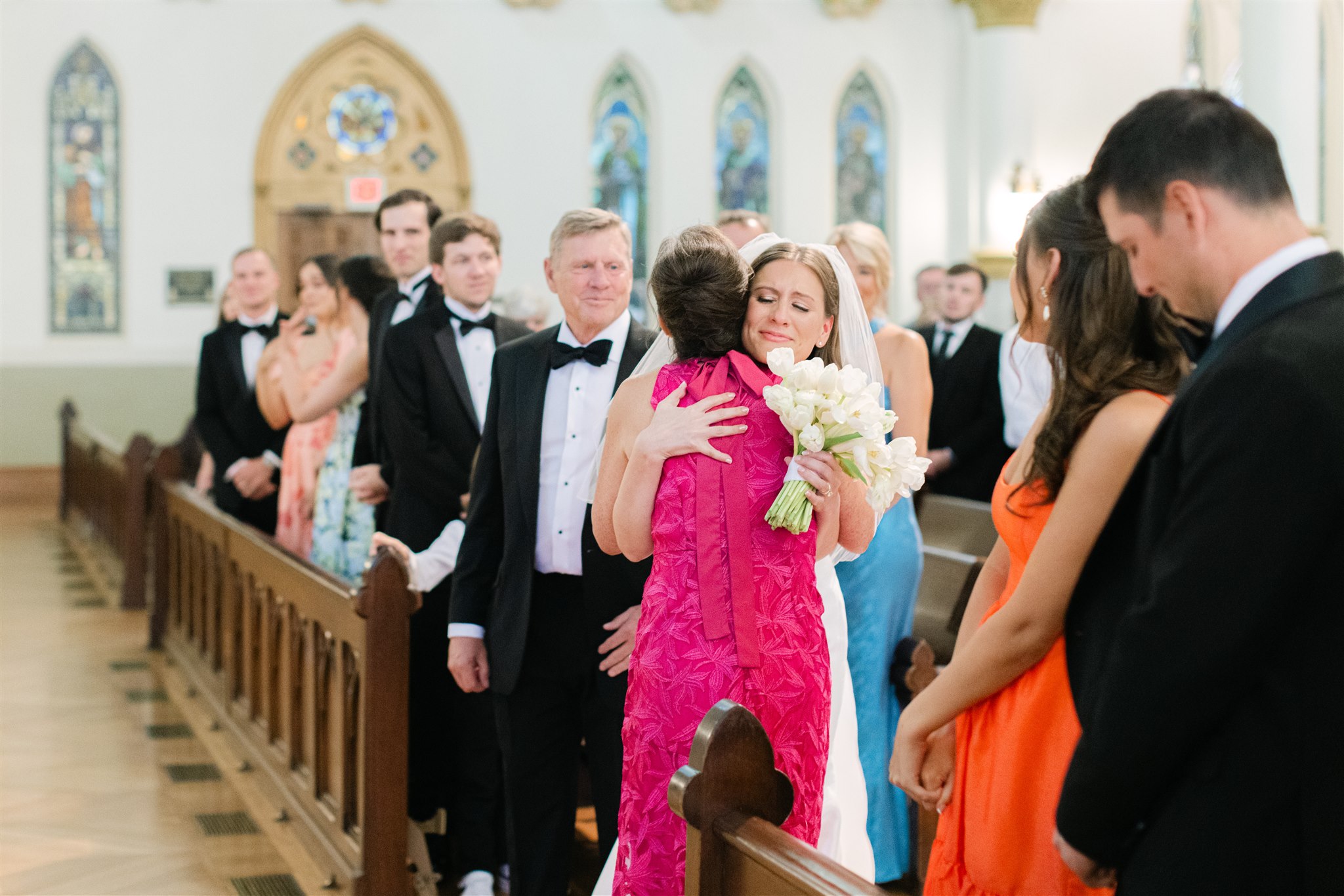 bride walking down the aisle with her mom and dada