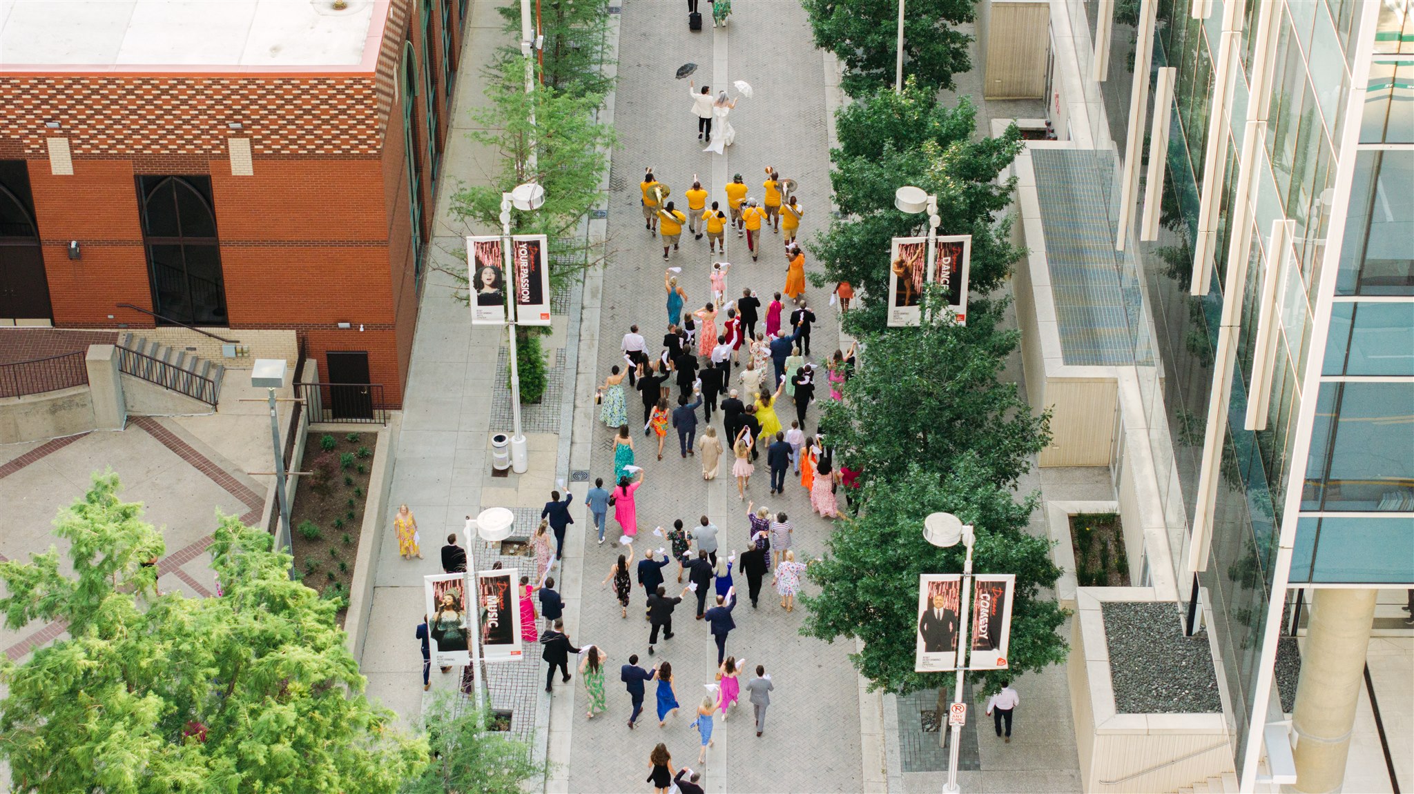 bride and groom with the second line band drone view