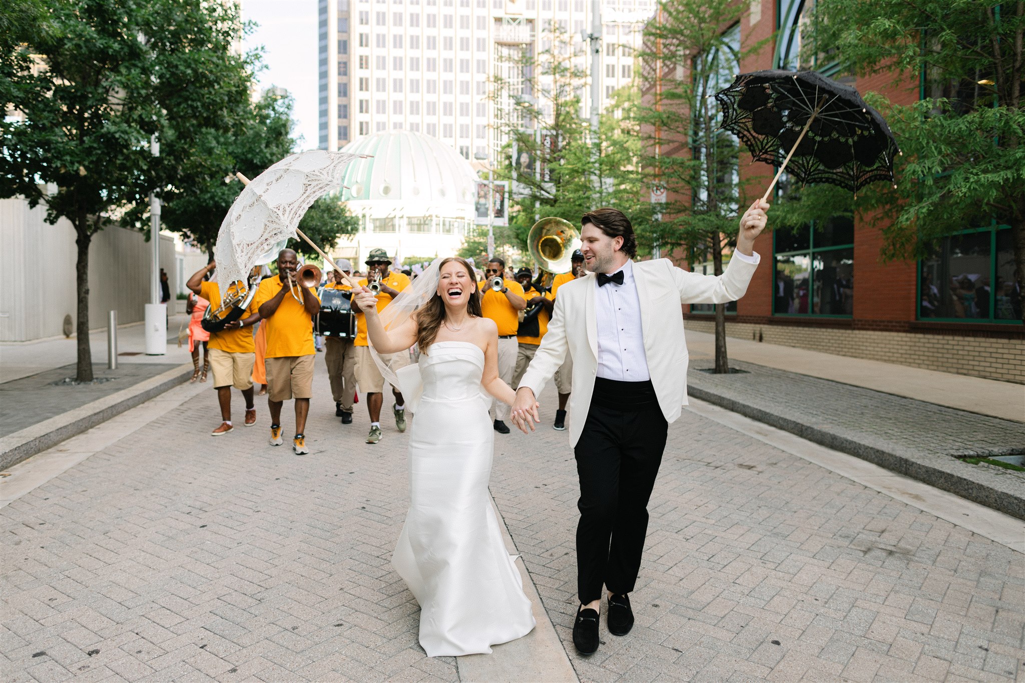 Bride and groom with a second line band in Dallas Texas