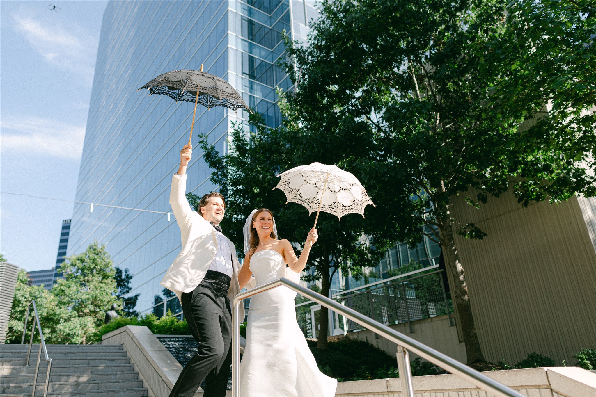 bride and groom with their parasols