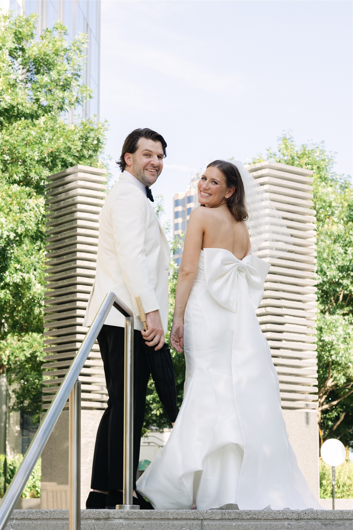 bride and groom with their parasols