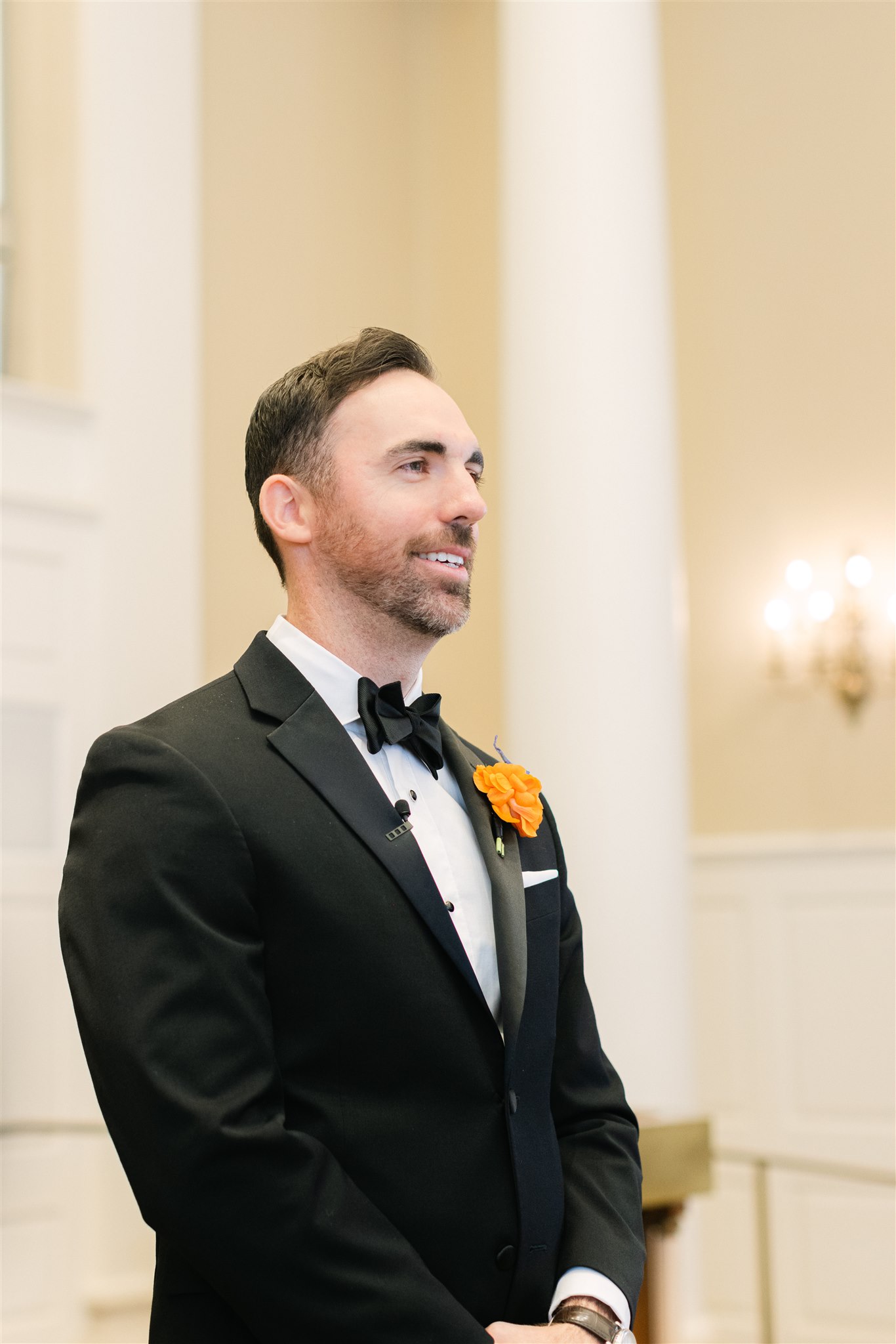 groom looking at his bride walk down the aisle