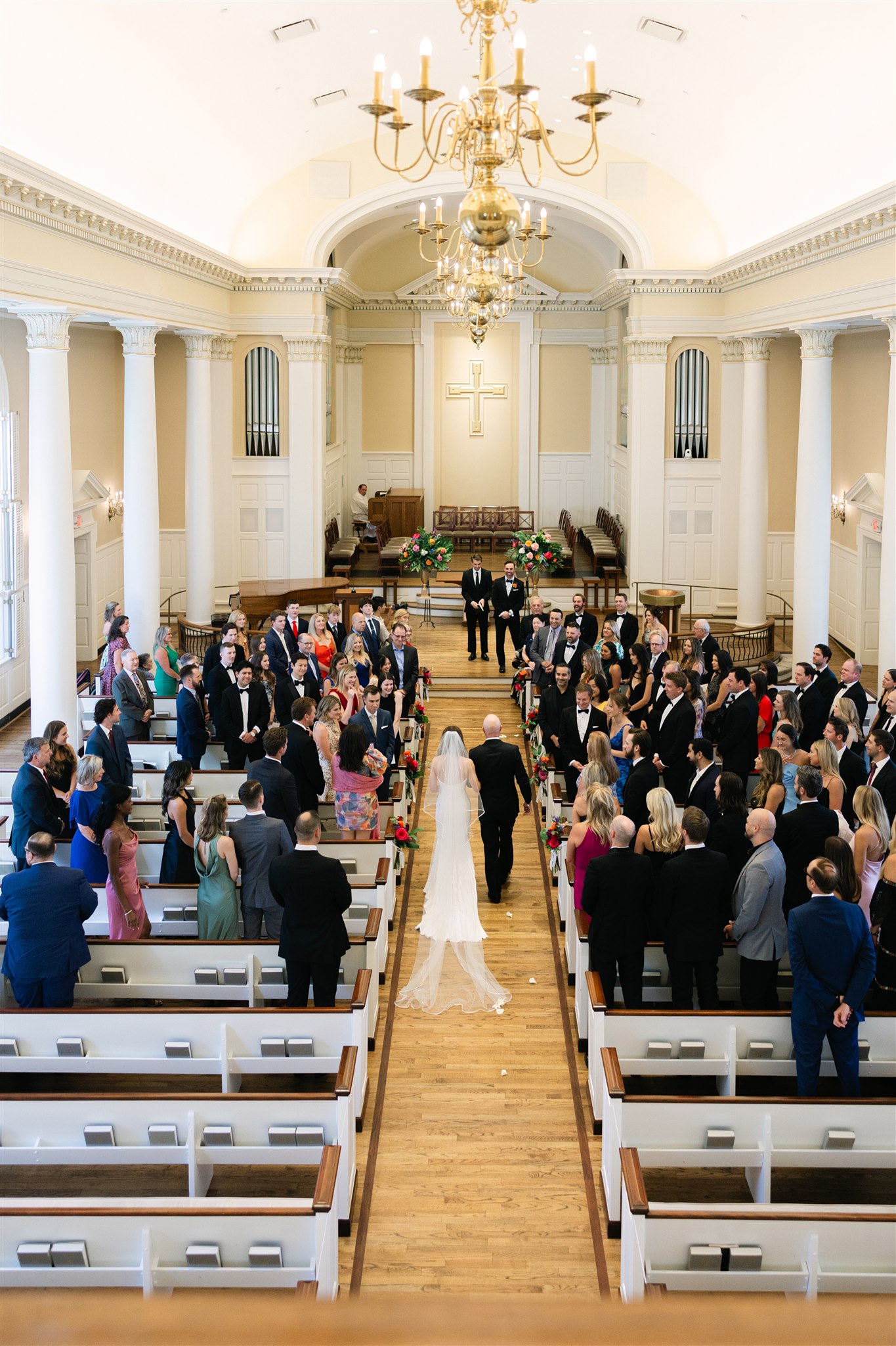 bride walking down the aisle during her wedding ceremony at Perkins Chapel