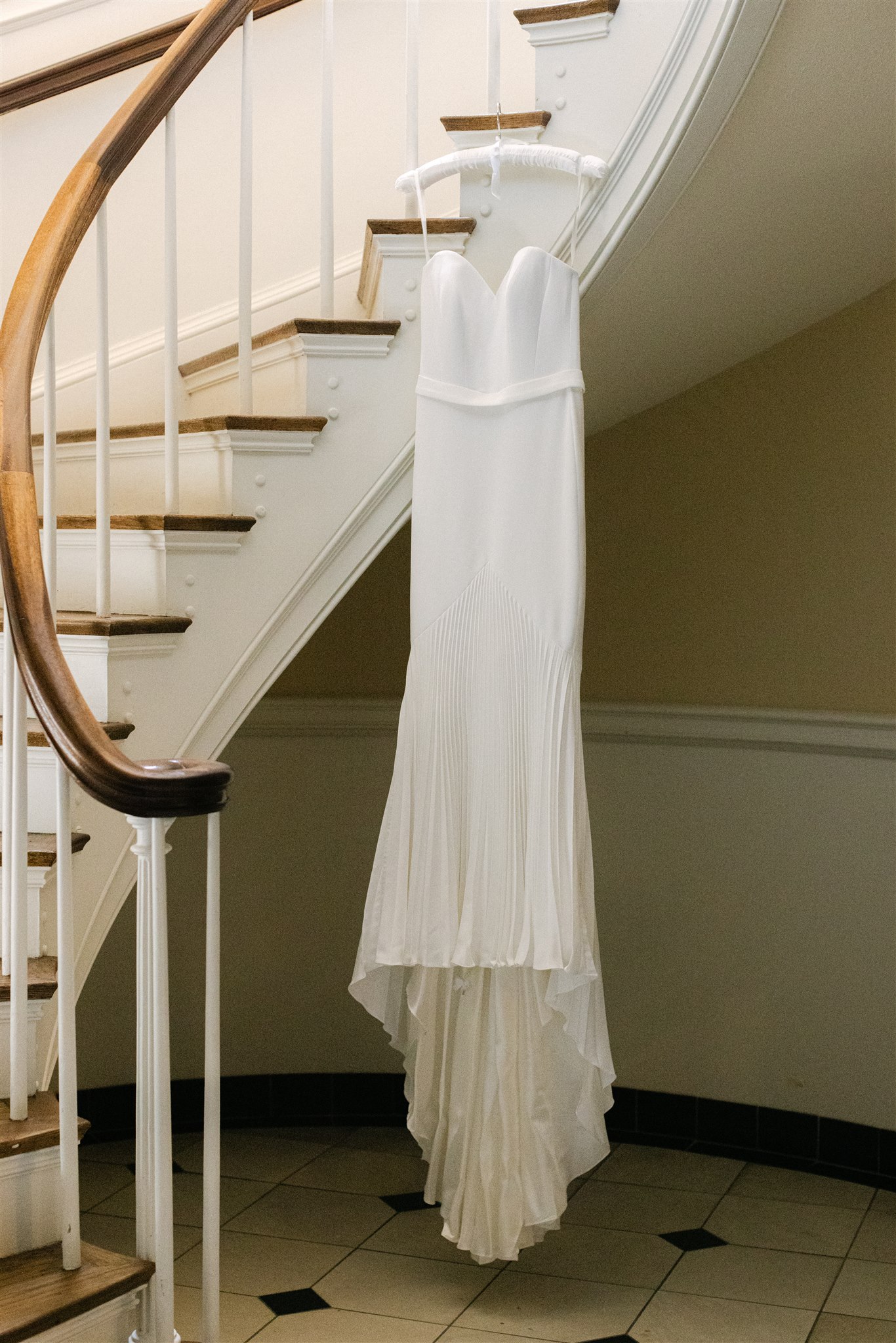 Wedding Dress hanging from a staircase