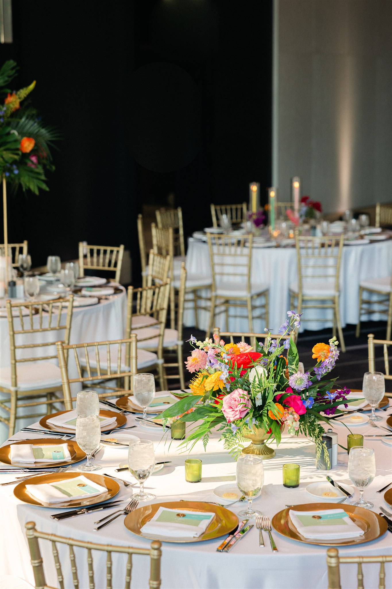 Wedding reception at JW Marriott tables set with colorful flower arrangements on top