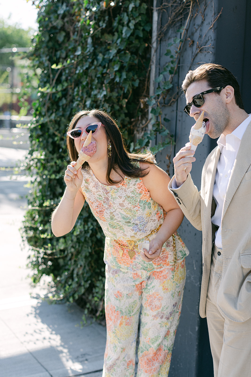 Man & a woman eating ice cream with sunglasses on