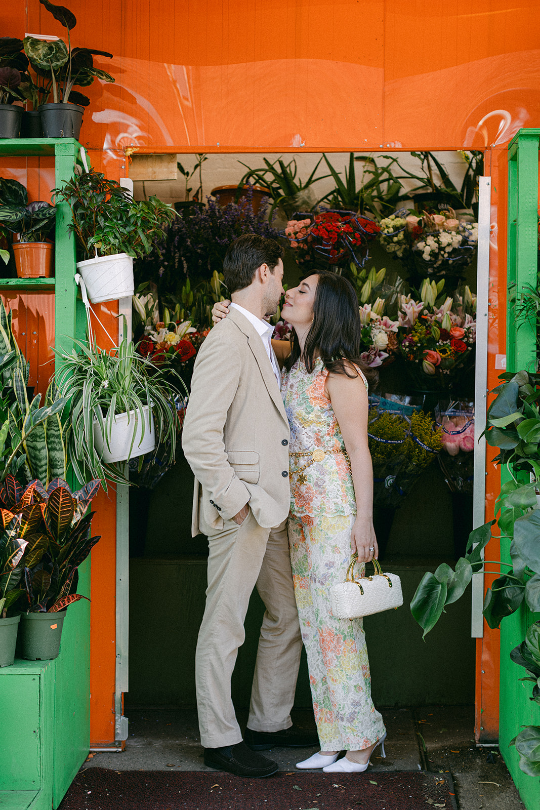 man and a woman outside a flower bodega in NYC