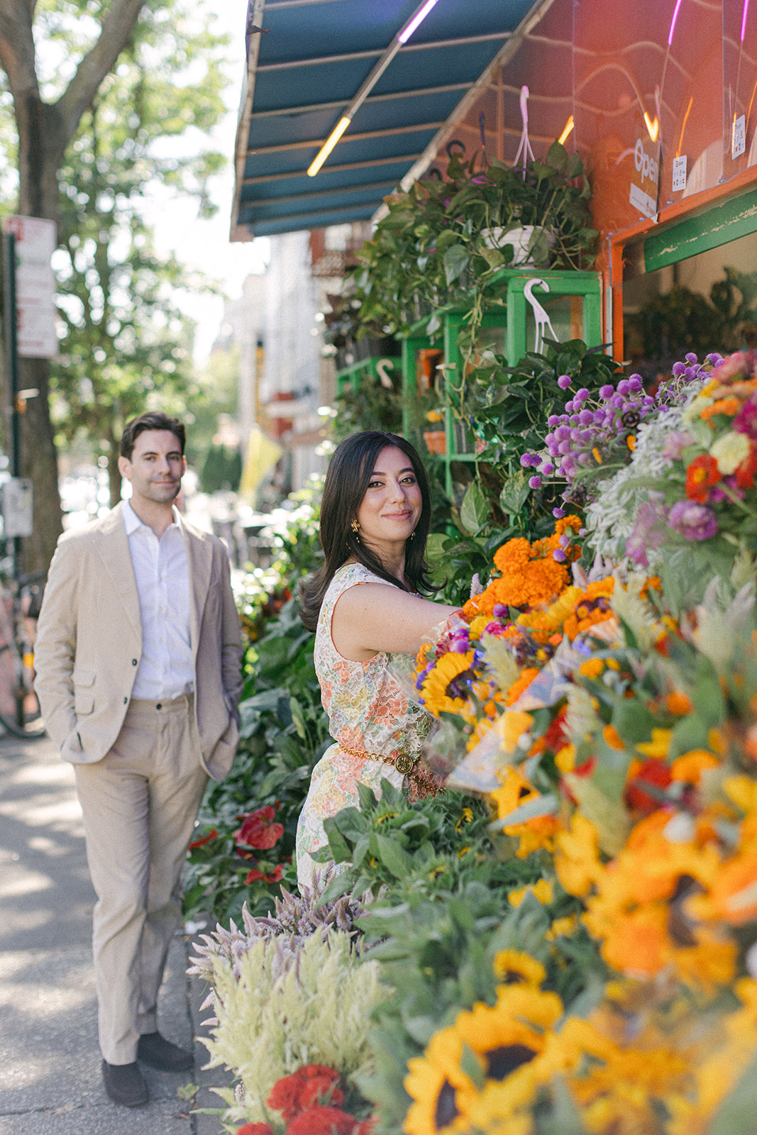 man and a woman outside a flower bodega in NYC