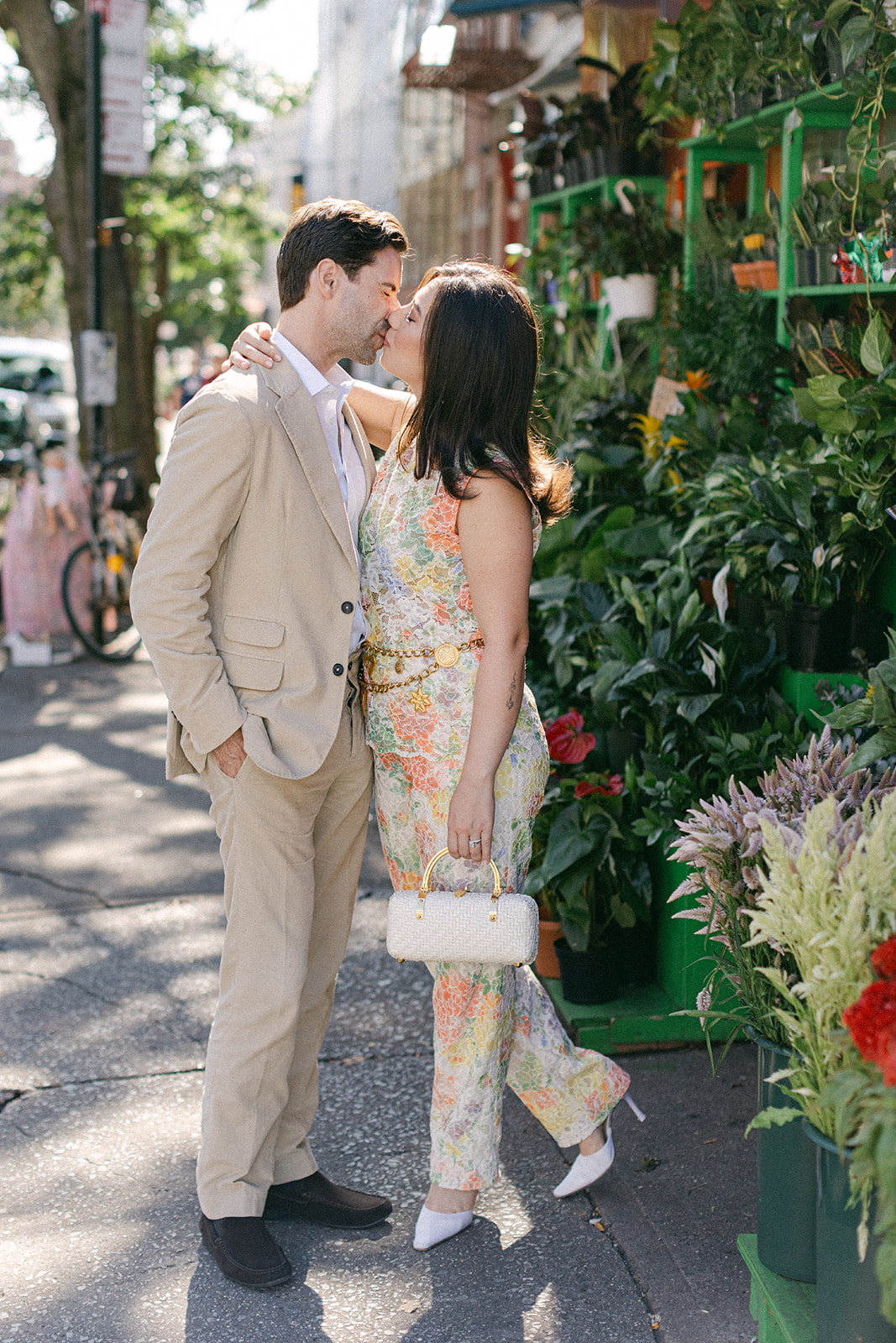 man and a woman outside a flower bodega in NYC