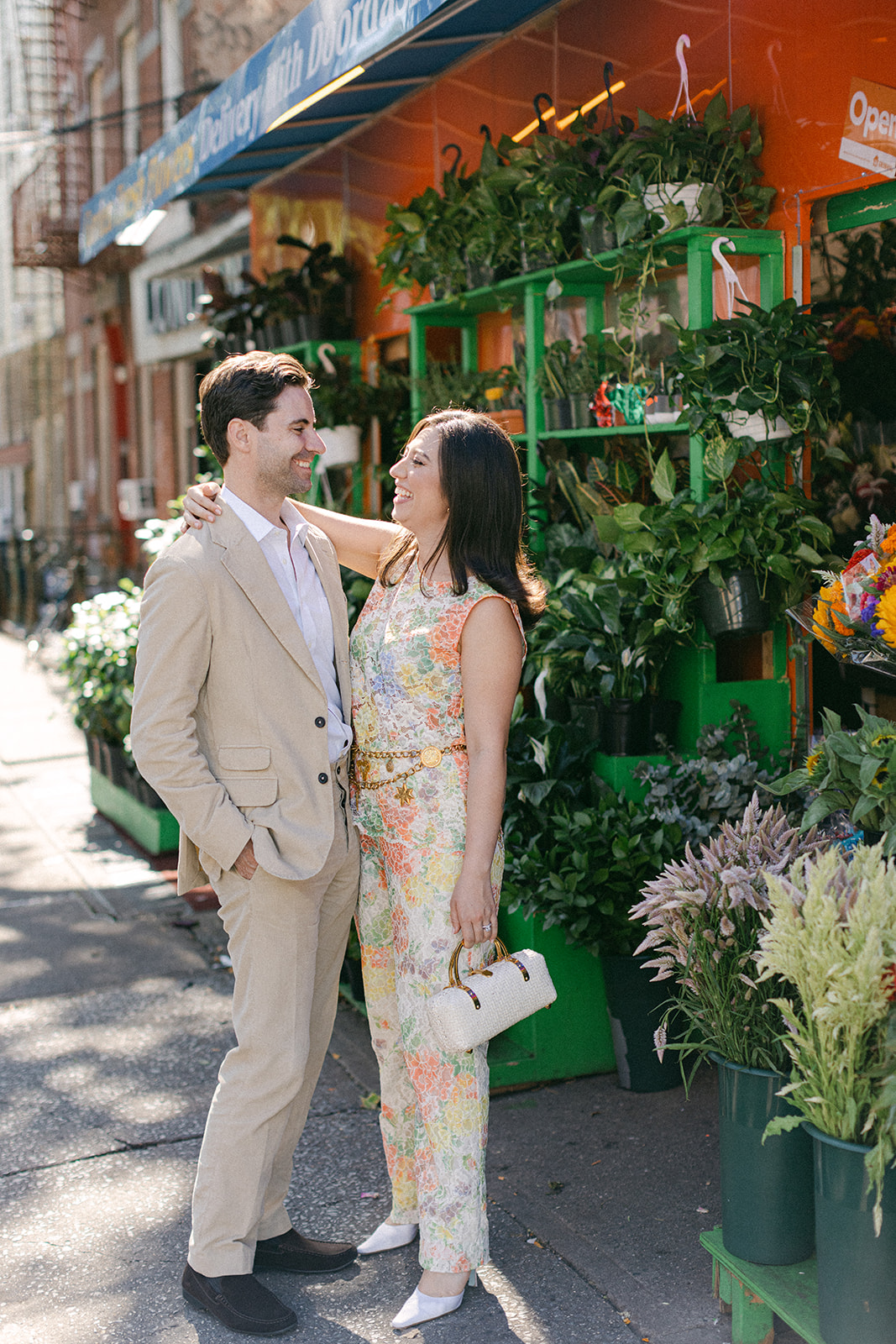 man and a woman outside a flower bodega in NYC