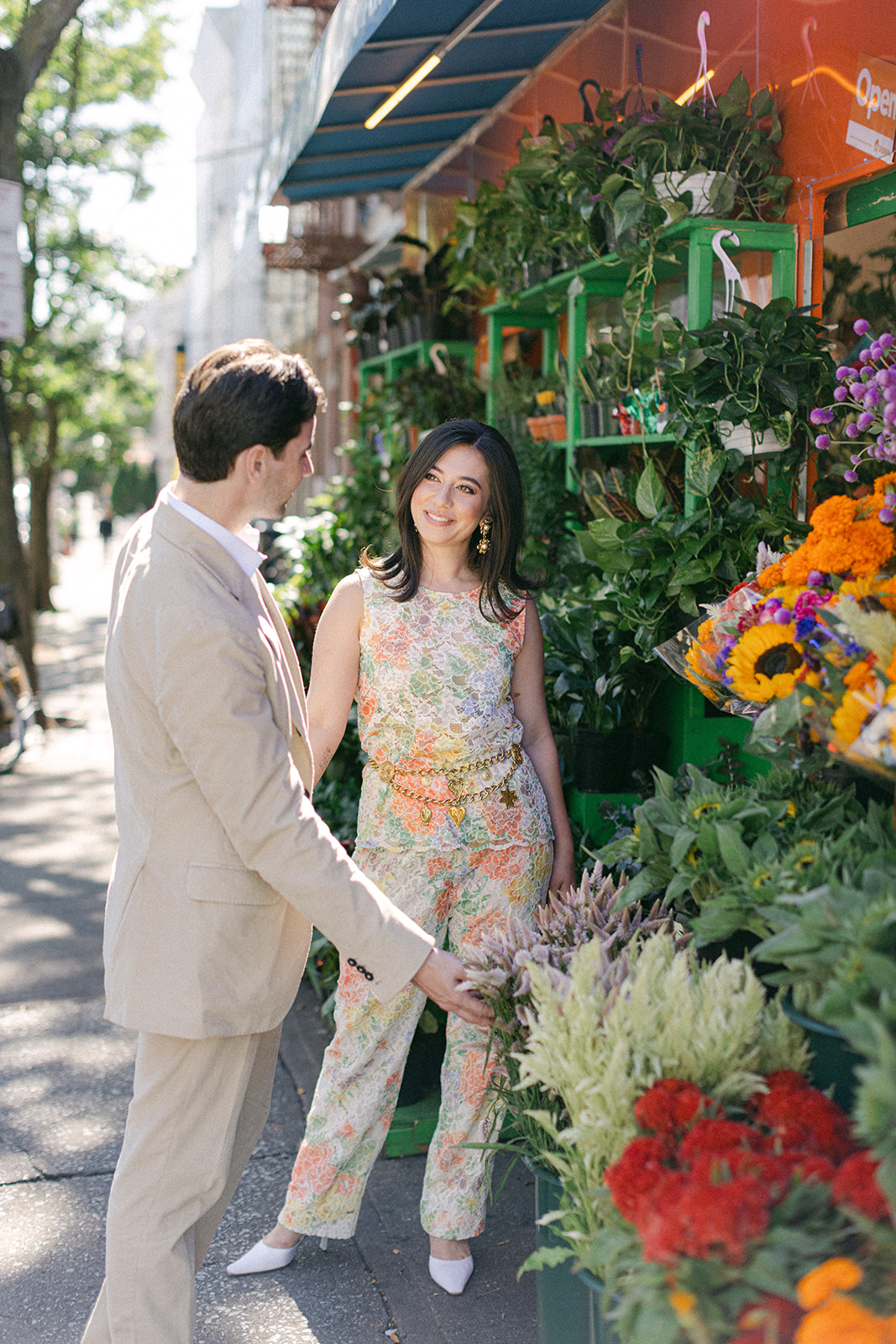 man and a woman outside a flower bodega in NYC