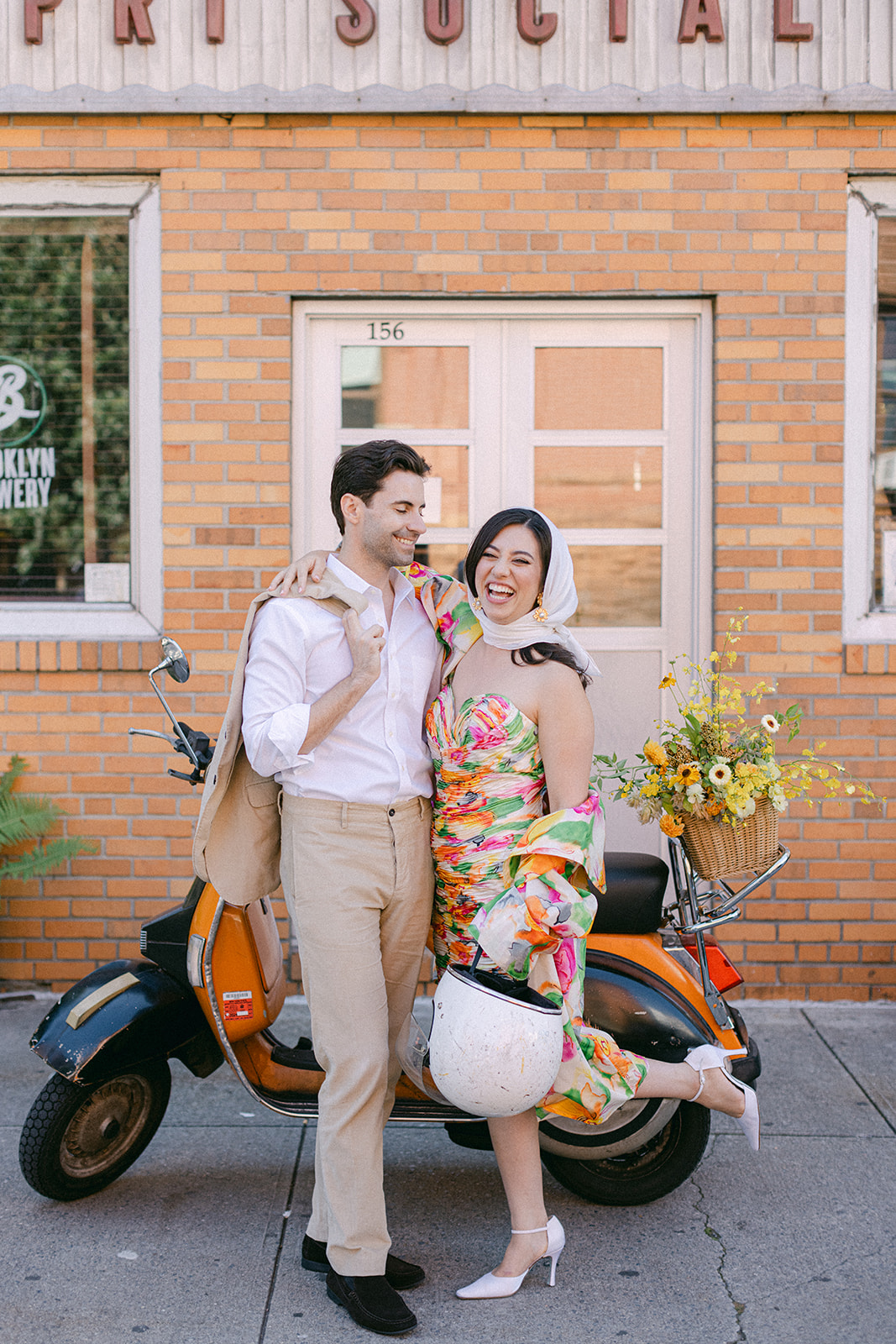 bride and groom in front of a vespa after their European inspired elopement in NYC