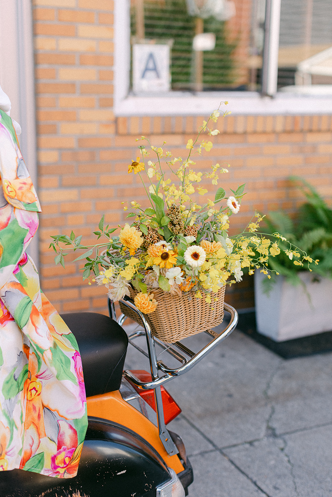 A basket of yellow flowers on a vespa for an elopement in NYC