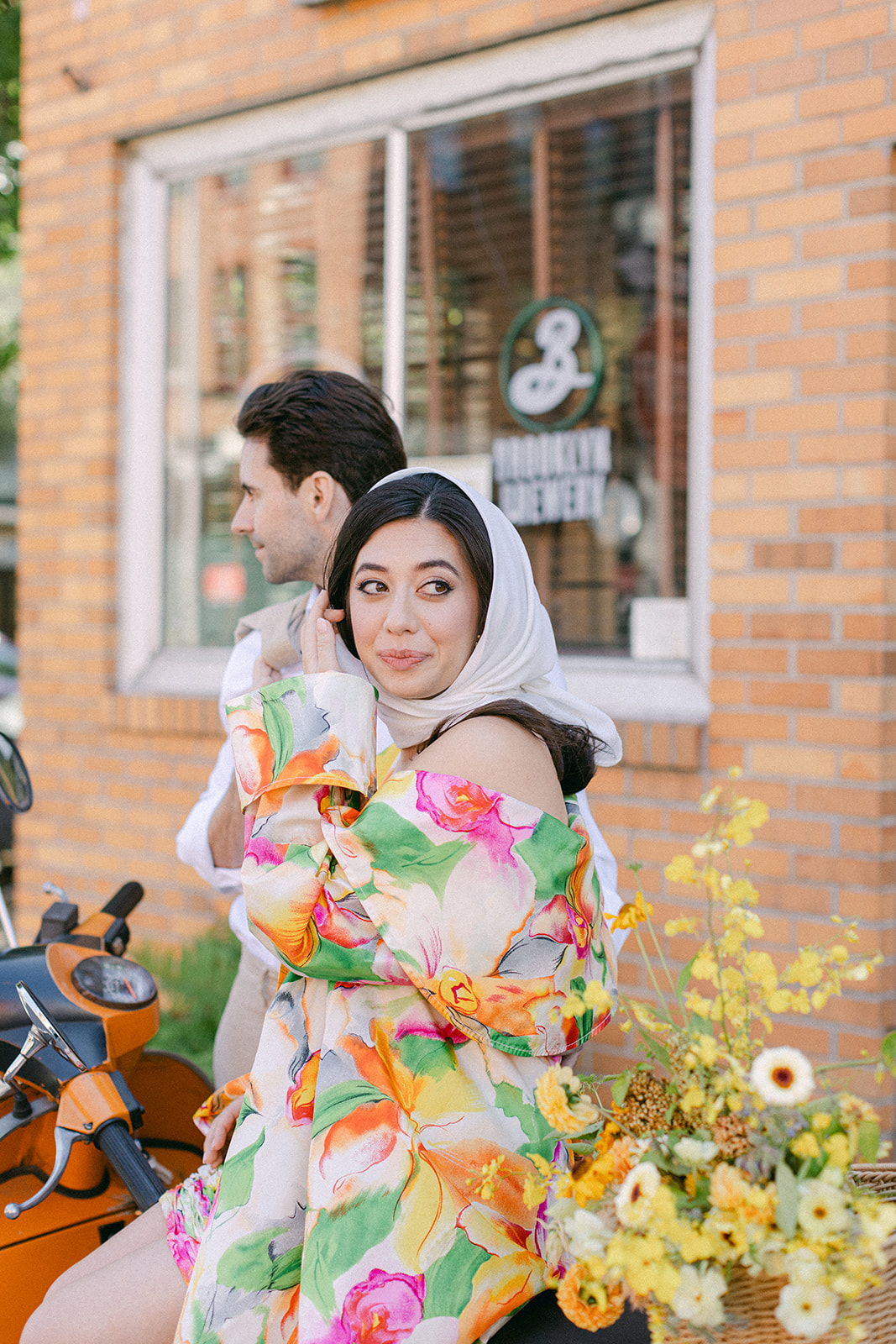 bride and groom in front of a vespa after their European inspired elopement in NYC