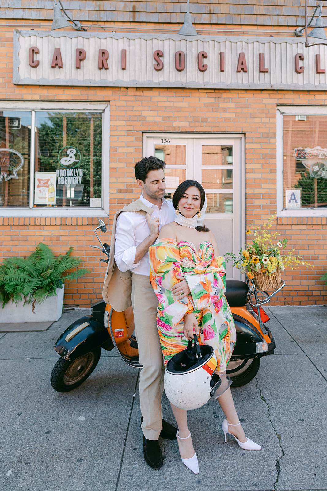 bride and groom in front of a vespa after their European inspired elopement in NYC