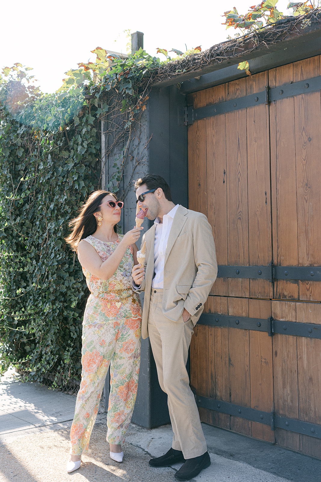 Man & a woman eating ice cream with sunglasses on