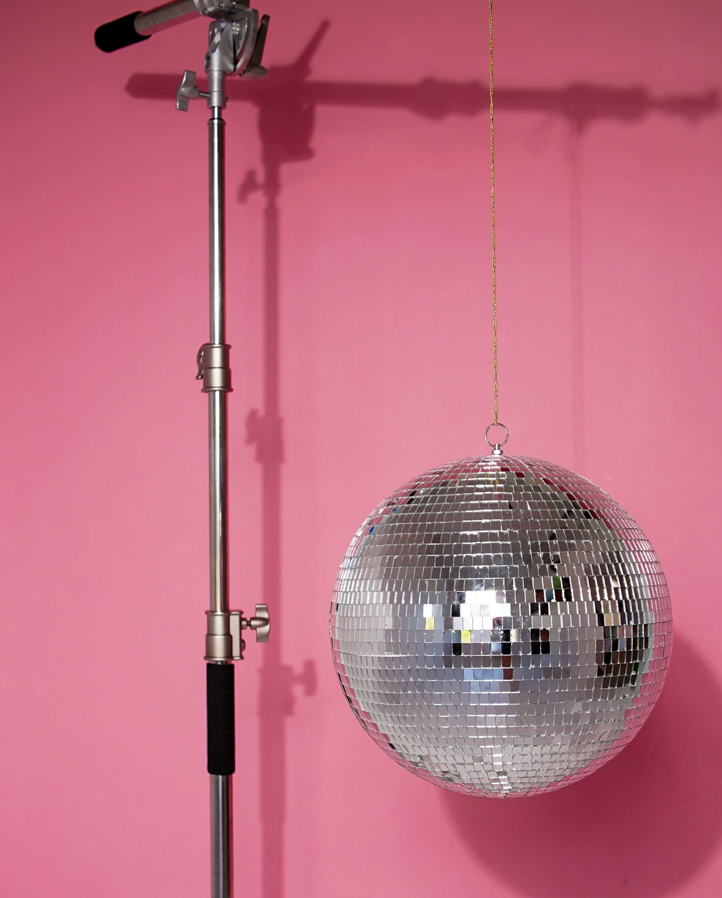 Pink seamless back drop with a disco ball at The Glossary