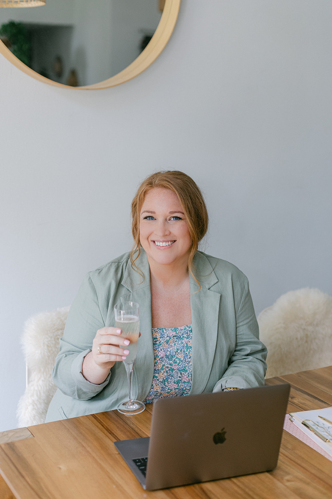 A girl holding a glass of champagne during her brand photoshoot at Studio 918 in Dallas, Texas