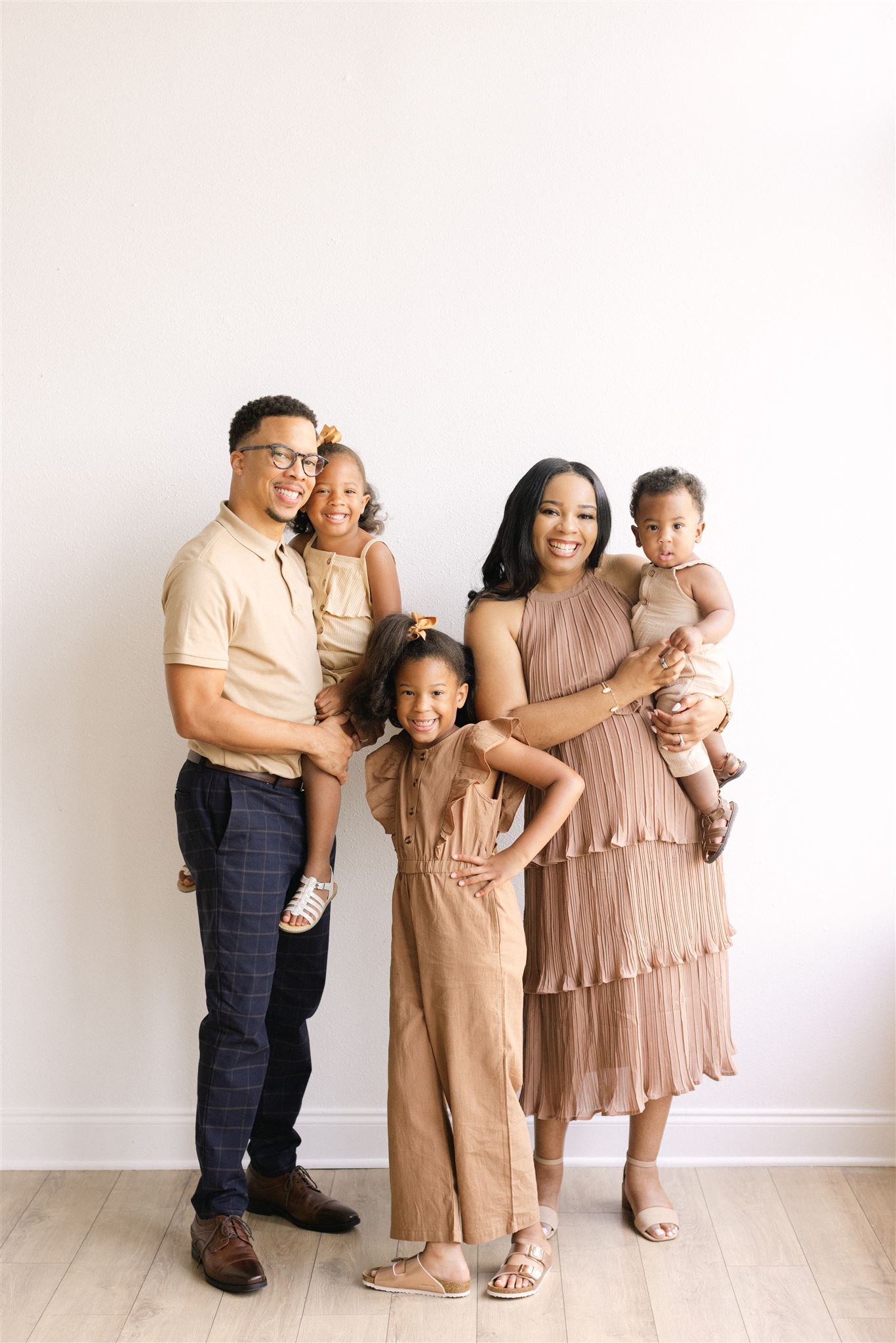 A couple with their 3 kids at The Lumen Room Lifestyle in Dallas, Texas