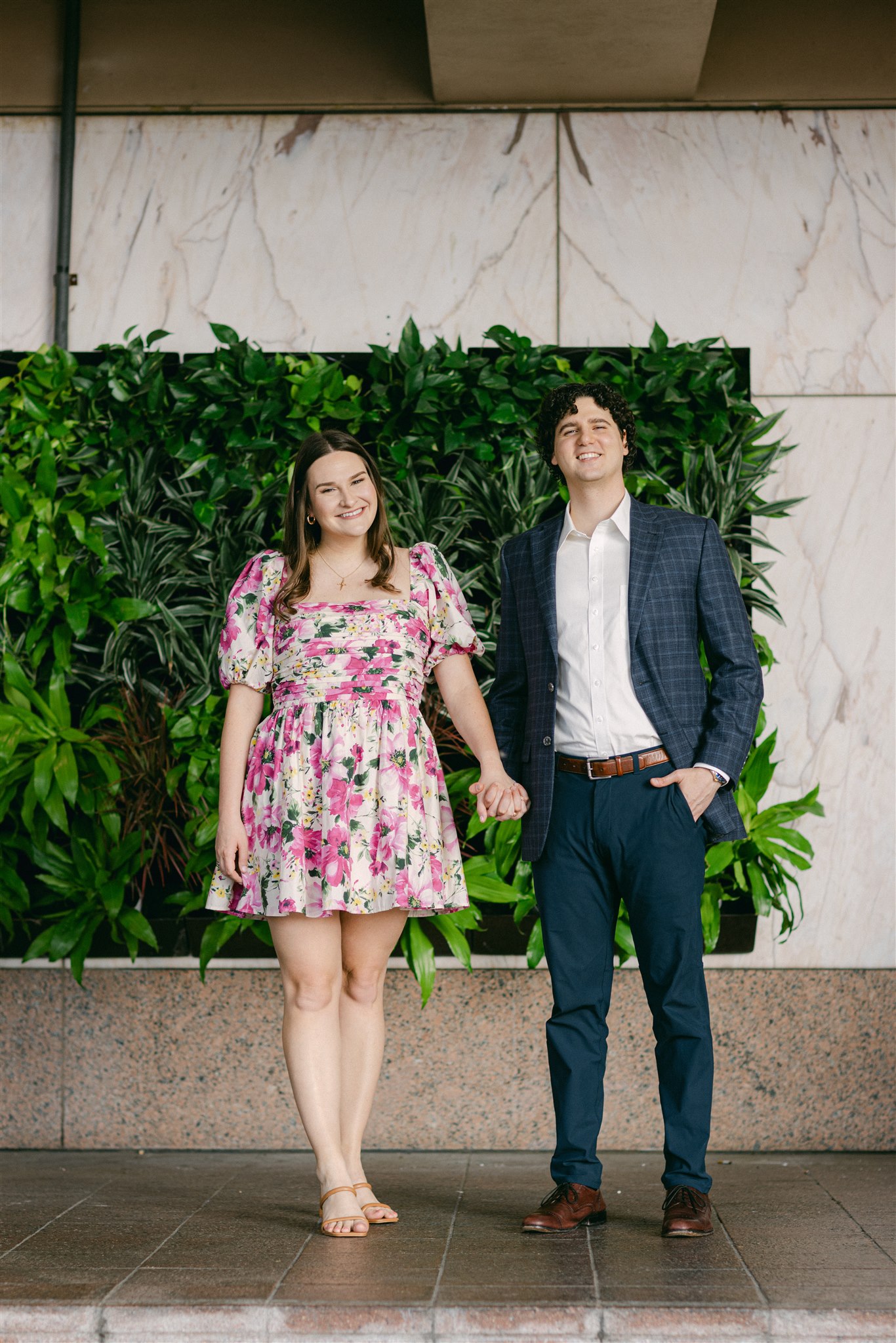 A couple holding hands during their downtown dallas engagement session