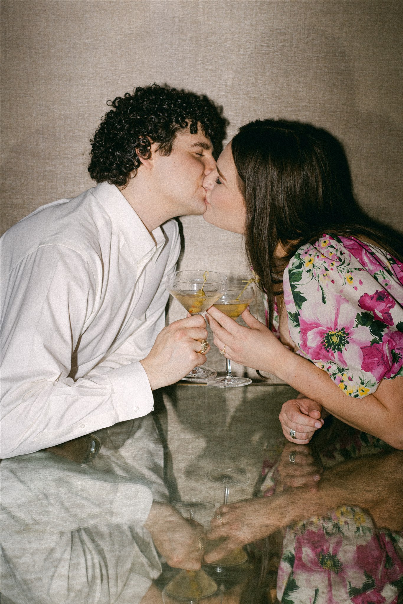 A couple drinking martini's during their engagement session in downtown dallas