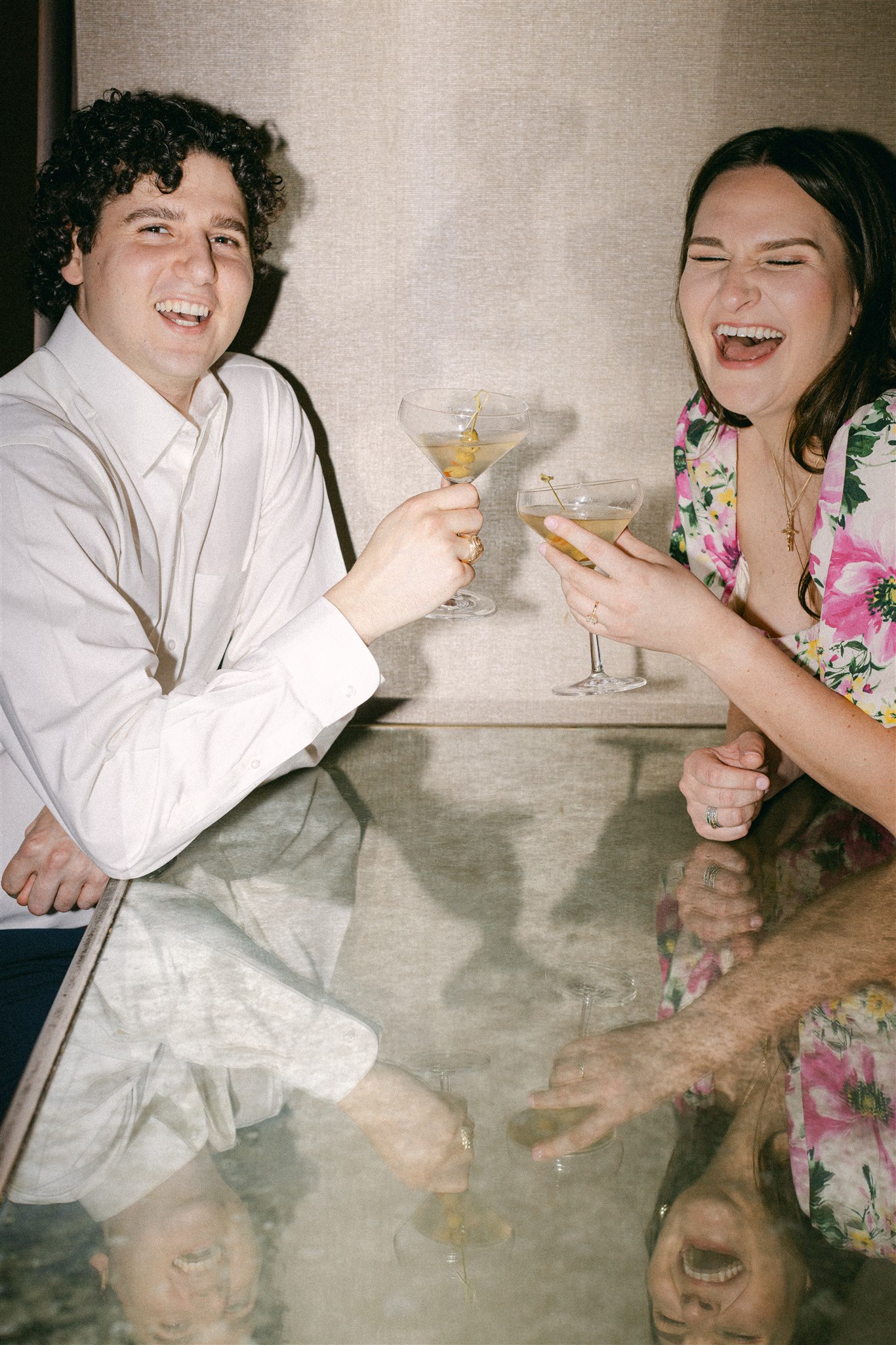 A couple drinking martini's during their engagement session in downtown dallas