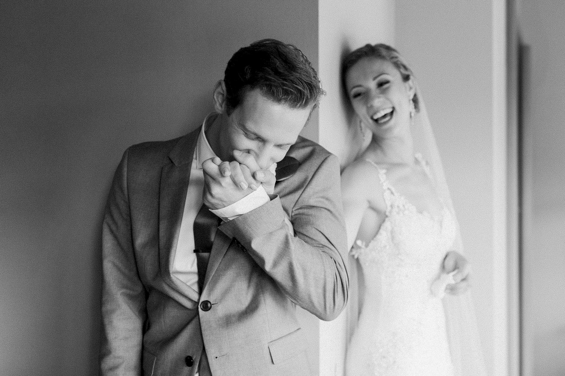 A couple during their first touch before their wedding ceremony