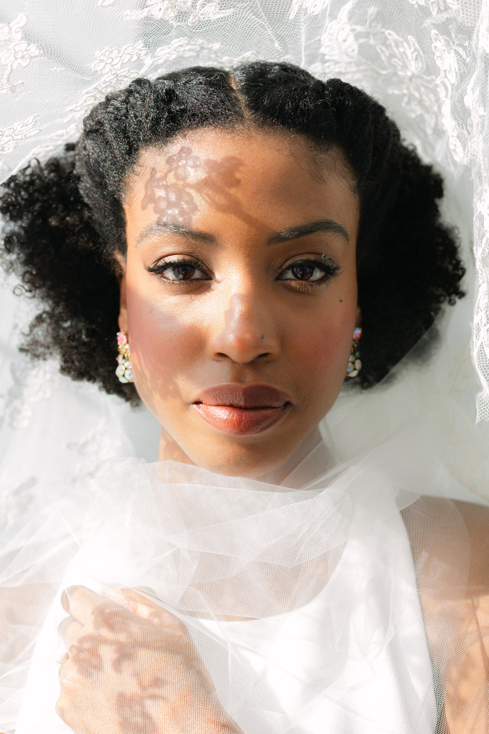 A close up photo of a bride underneath her wedding veil