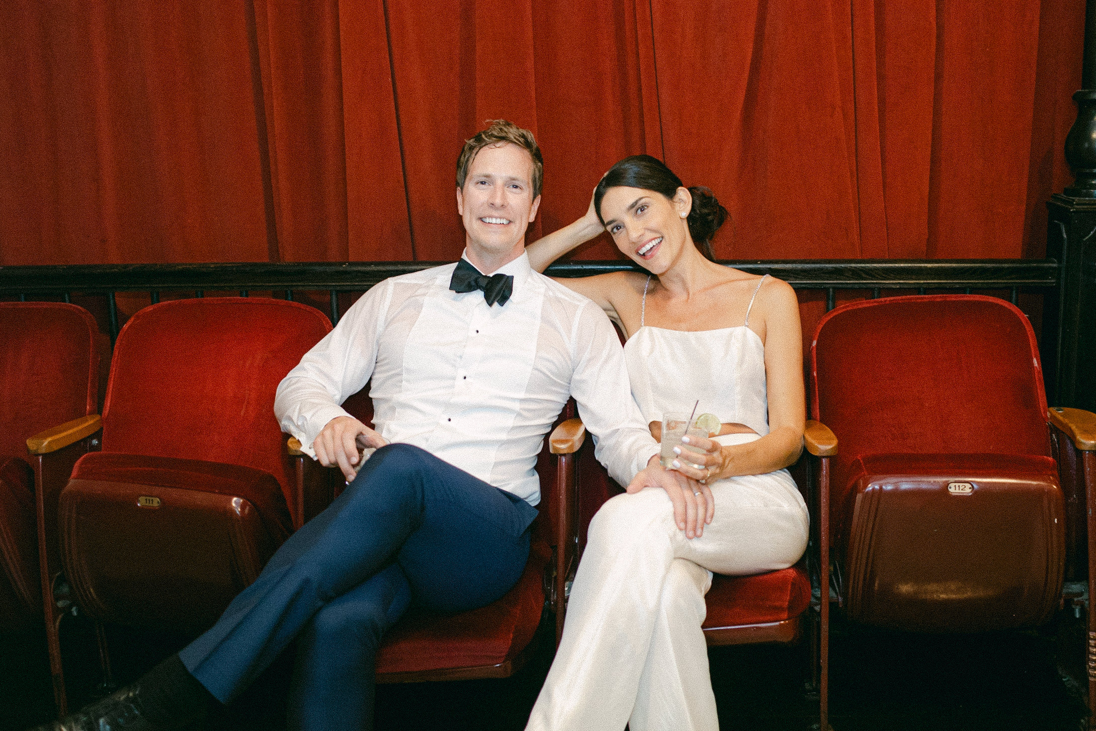 A bride and groom sitting in theatre seats during their wedding reception in New York