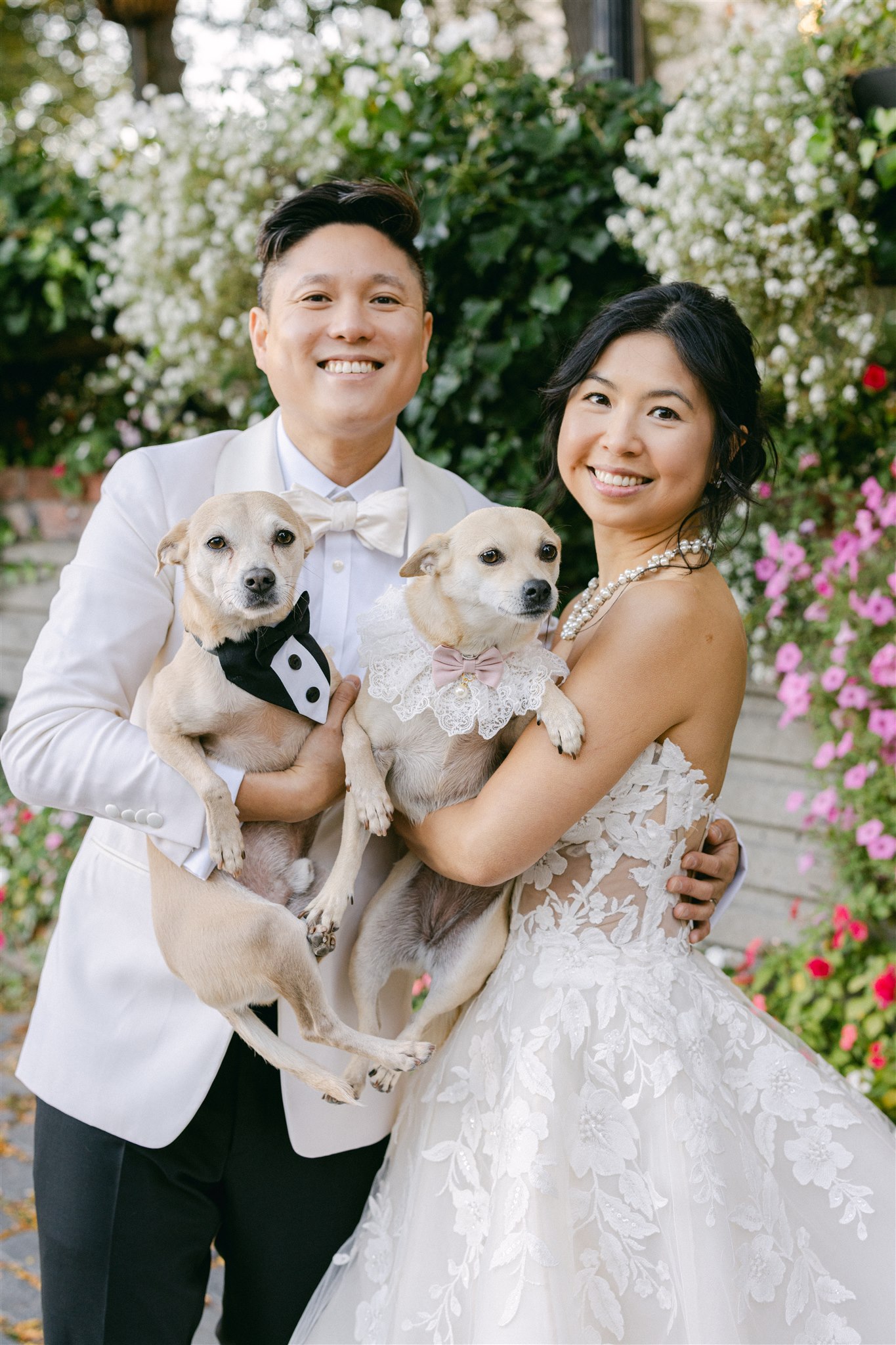 A couple holding their dogs during a wedding portrait session in New York