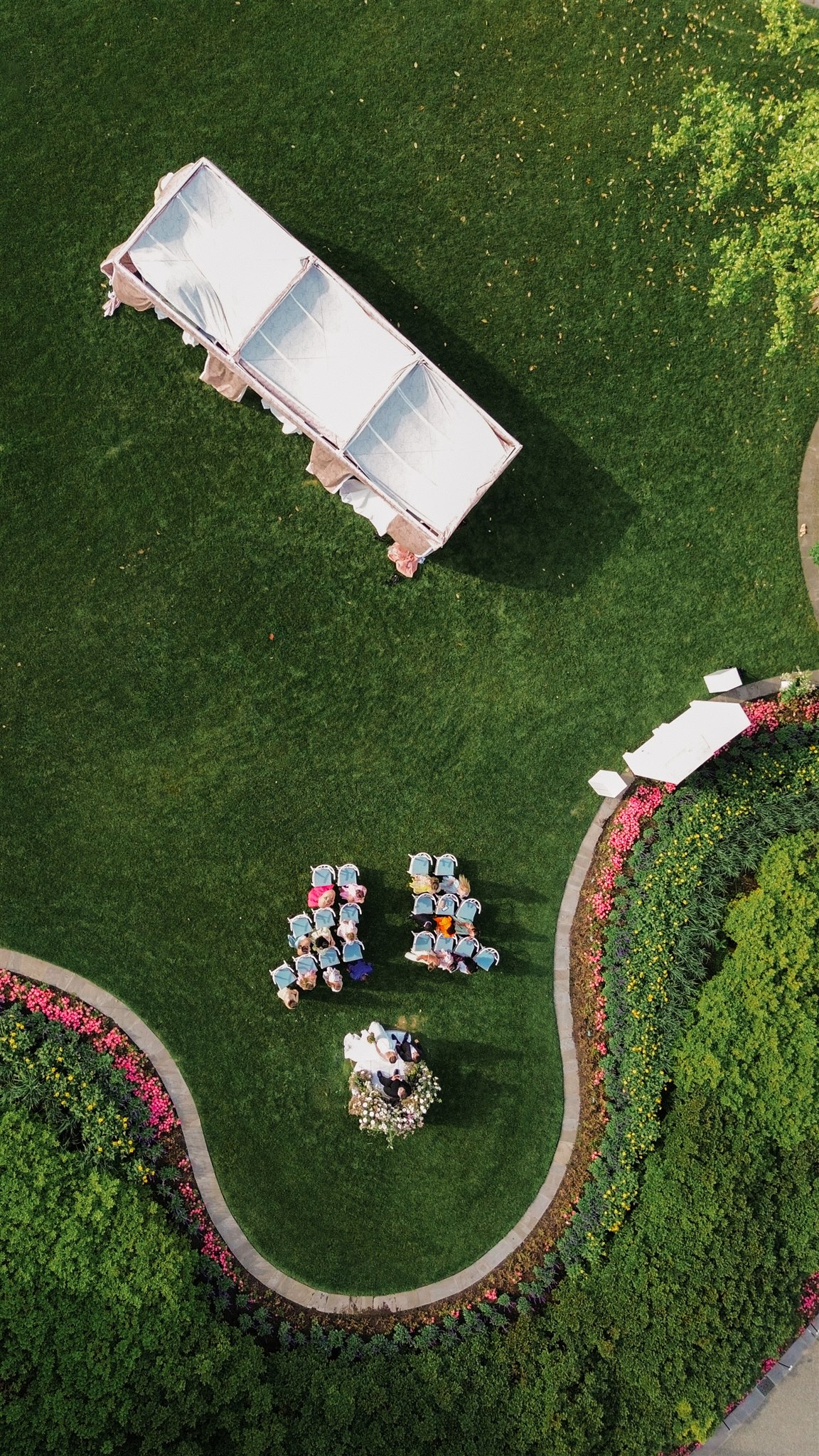 a view from above a wedding ceremony and wedding reception at the dallas arboretum