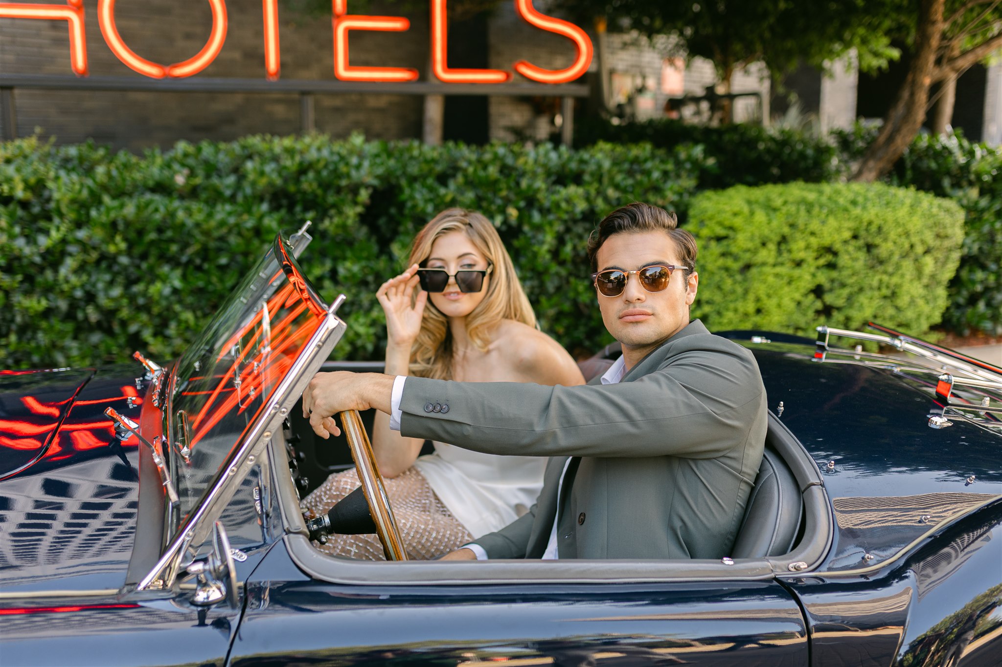 A wedding couple in a vintage getaway car