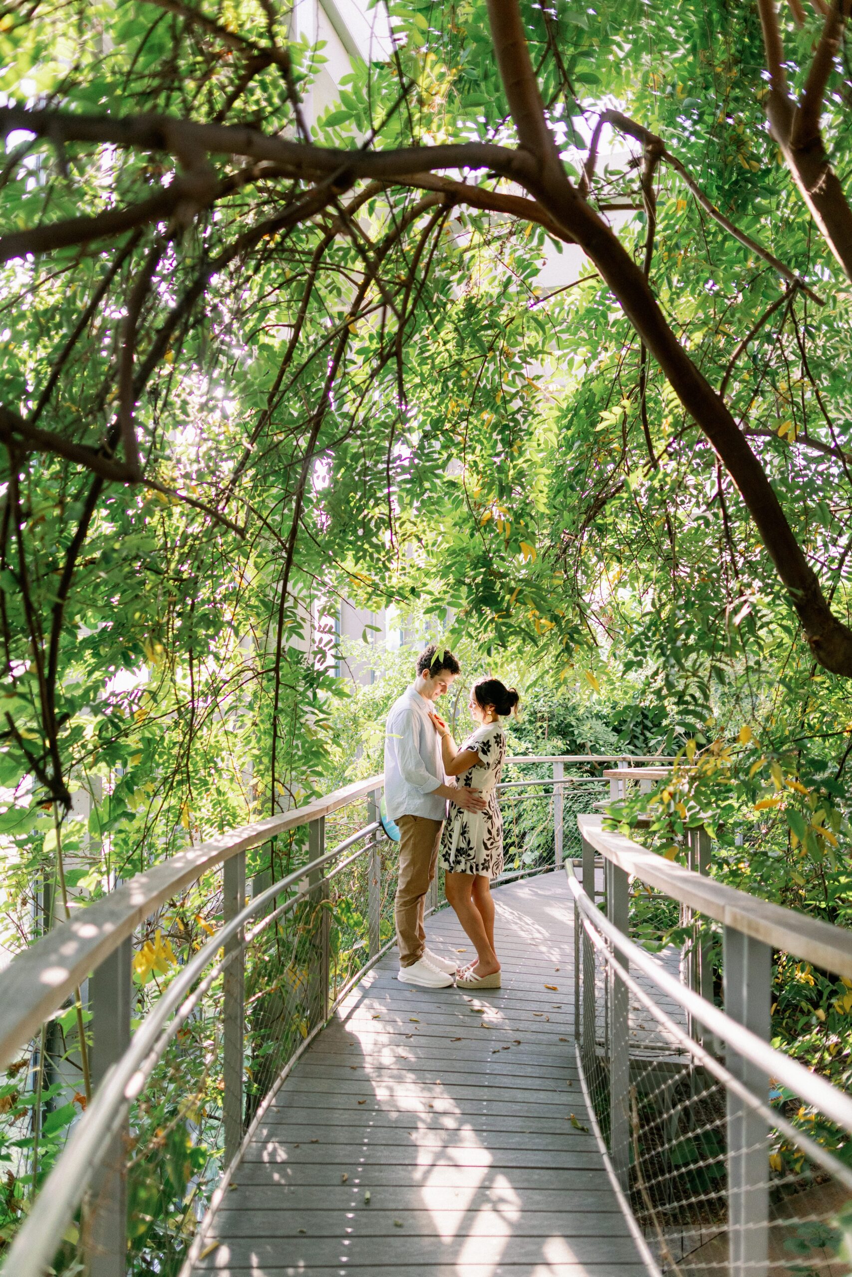 a man and a woman standing in the butterfly gardens at texas discovery part after their dallas proposal