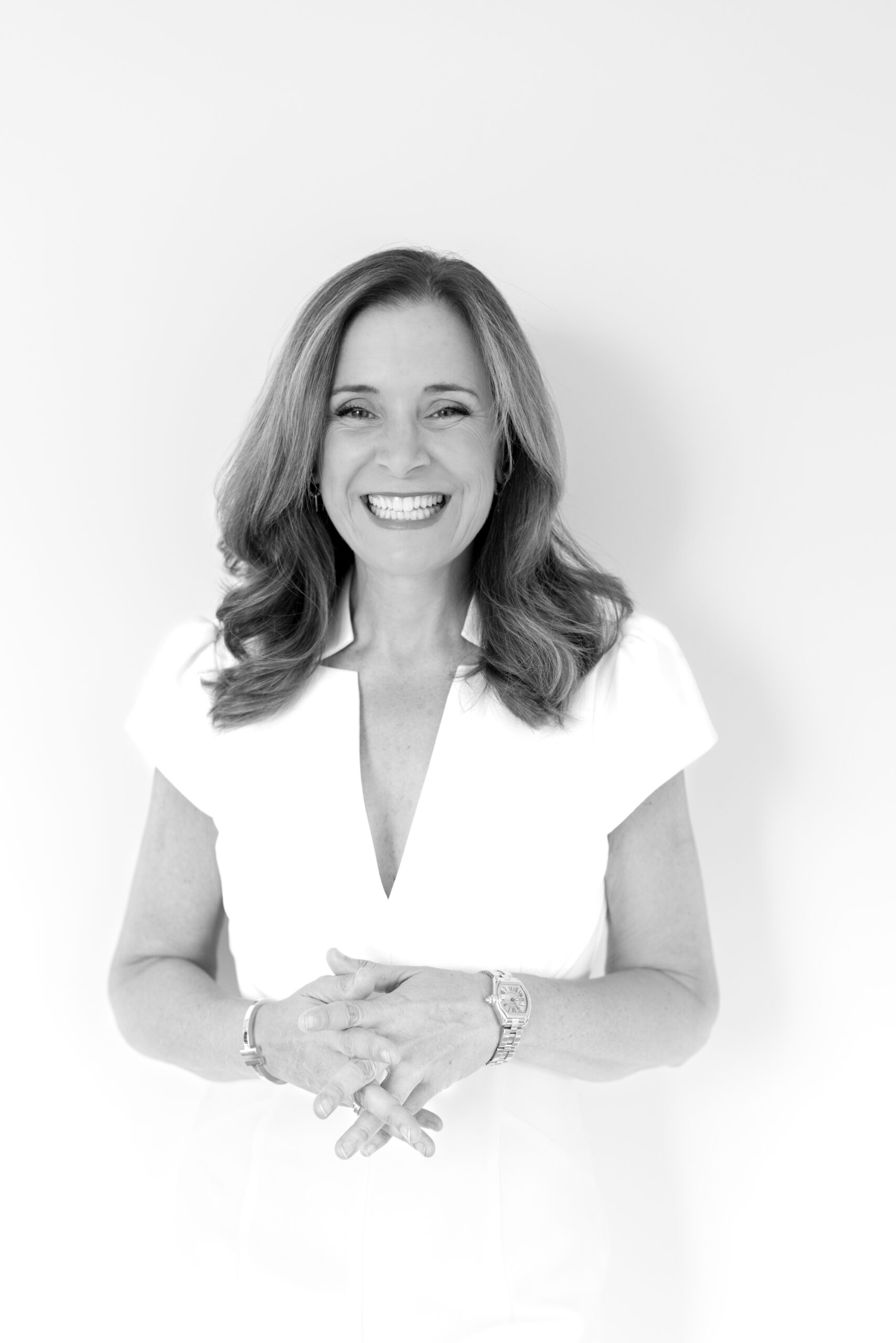 a black and white headshot of a woman in professional attire