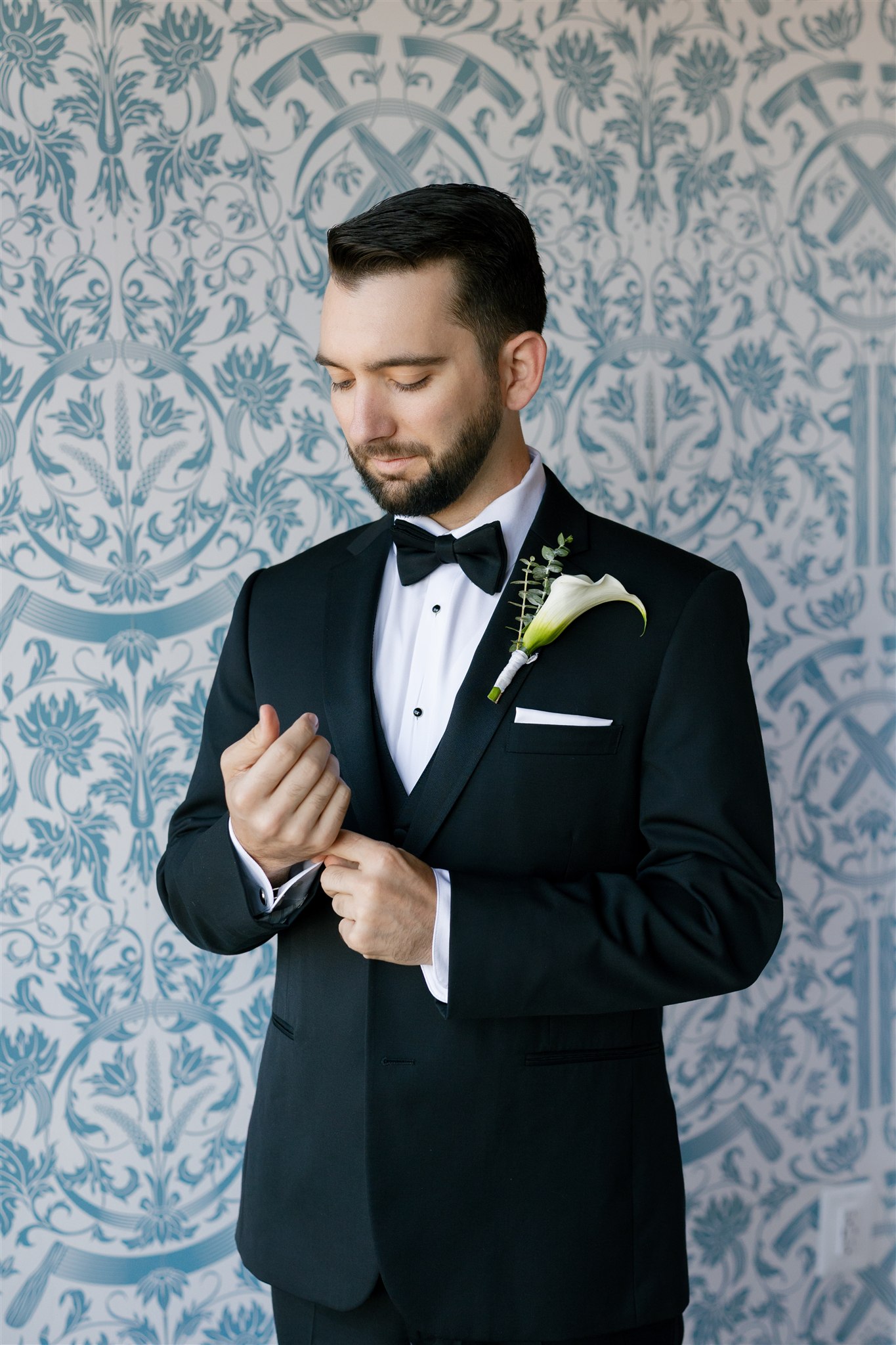 a groom wearing a black tux